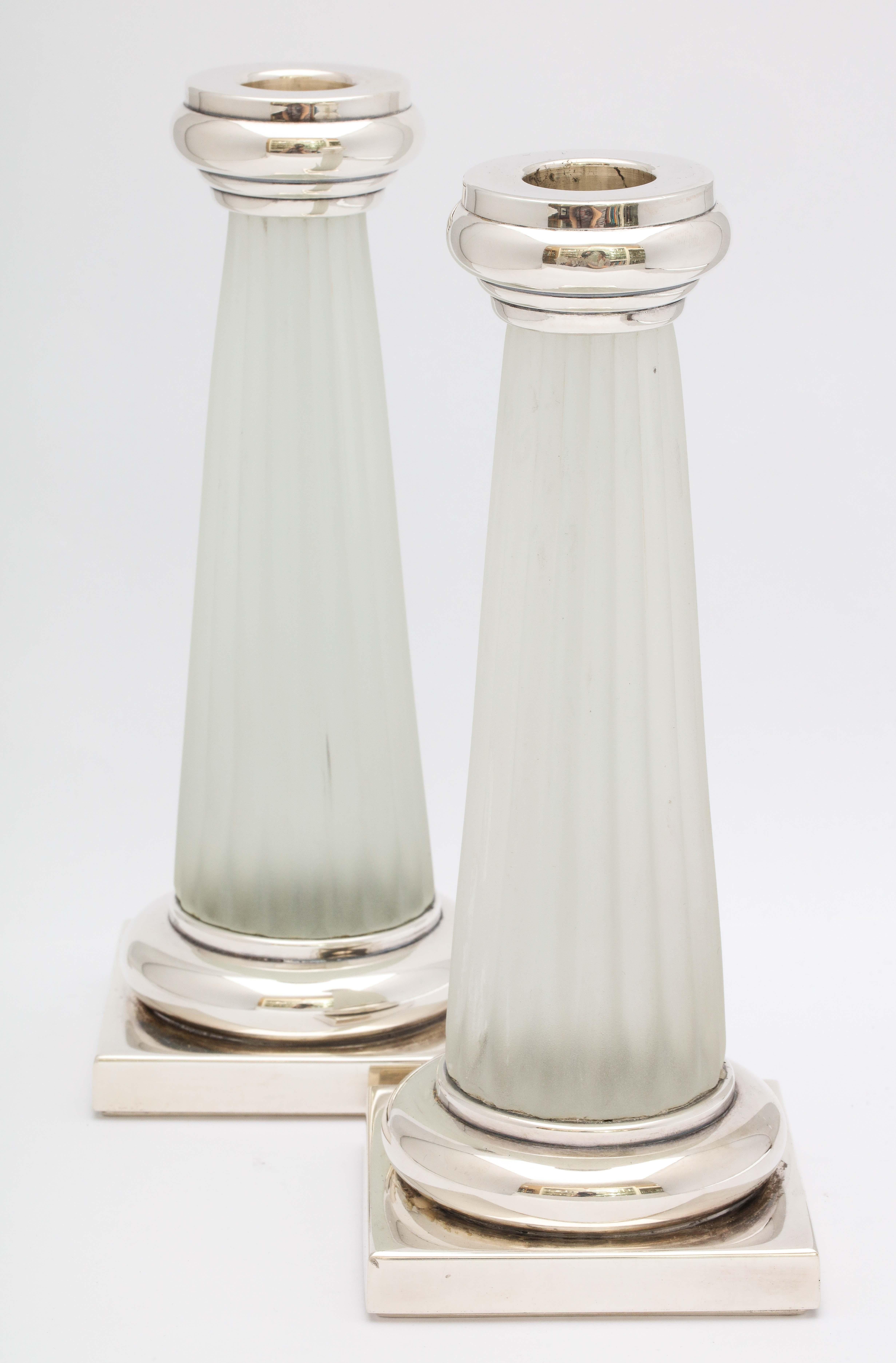 Pair of Neoclassical Style, sterling silver-mounted frosted glass candlesticks, Italy, circa 1950's. Each candlestick measures 8 1/2 inches high x 3 1/4 inches wide (across base) x 3 1/3 inches deep (across base). Not weighted. Timeless design. Dark