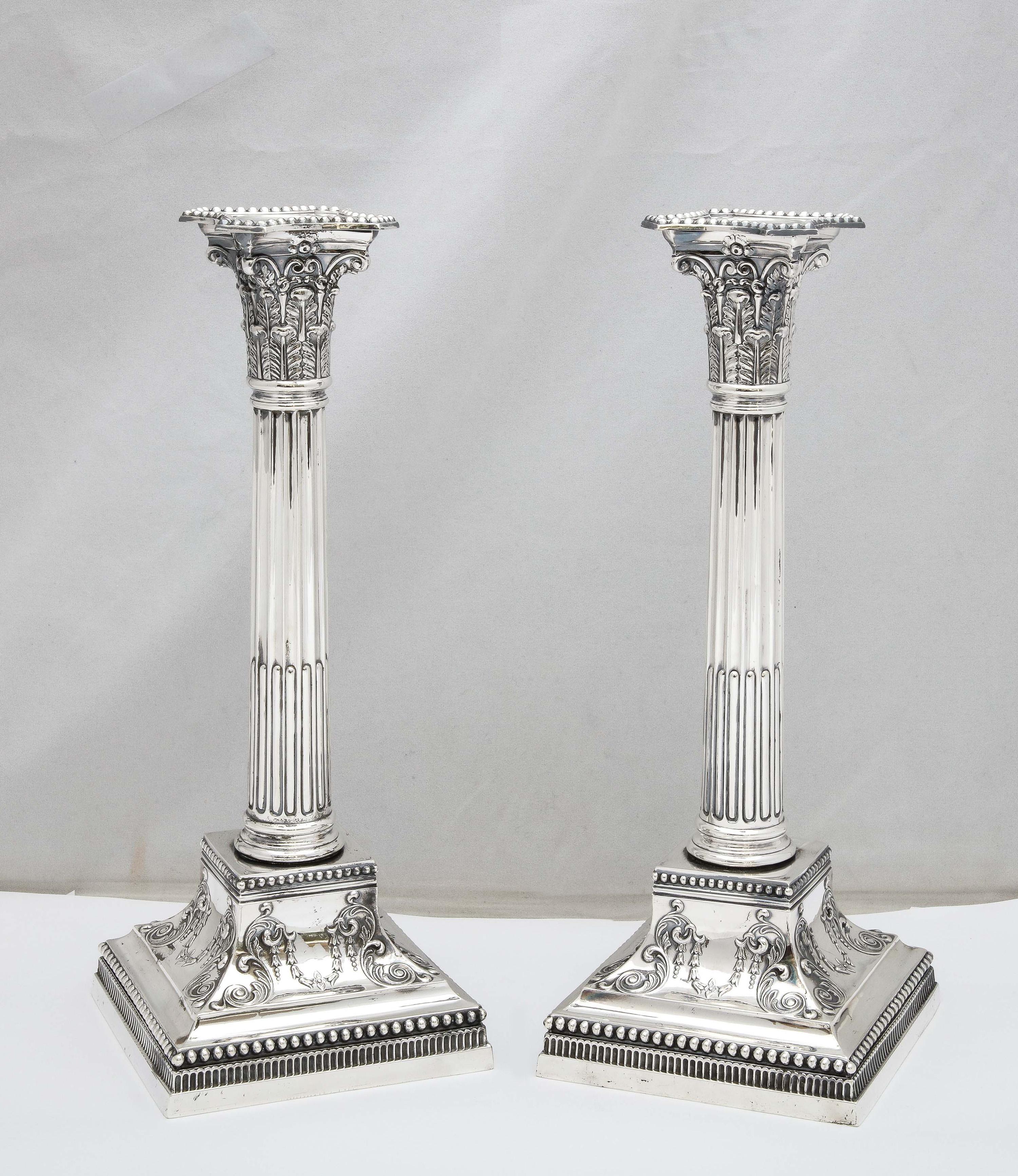 Pair of Edwardian Period, tall, Neoclassical-Style, sterling silver Corinthian column candlesticks, Sheffield, England, year-hallmarked for 1906, James Dixon and Sons - makers. Each candlestick measures 11 inches tall x 4 1/2 wide (at widest point