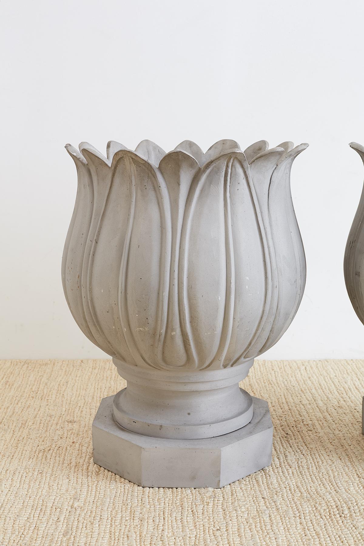 Fantastic pair of large neoclassical garden urns in the form of tulips. These planters or jardinières are constructed from thick aluminum hand-formed by a foundry in Los Angeles, CA. Mounted on octagonal plinths. Beautifully molded petals on the
