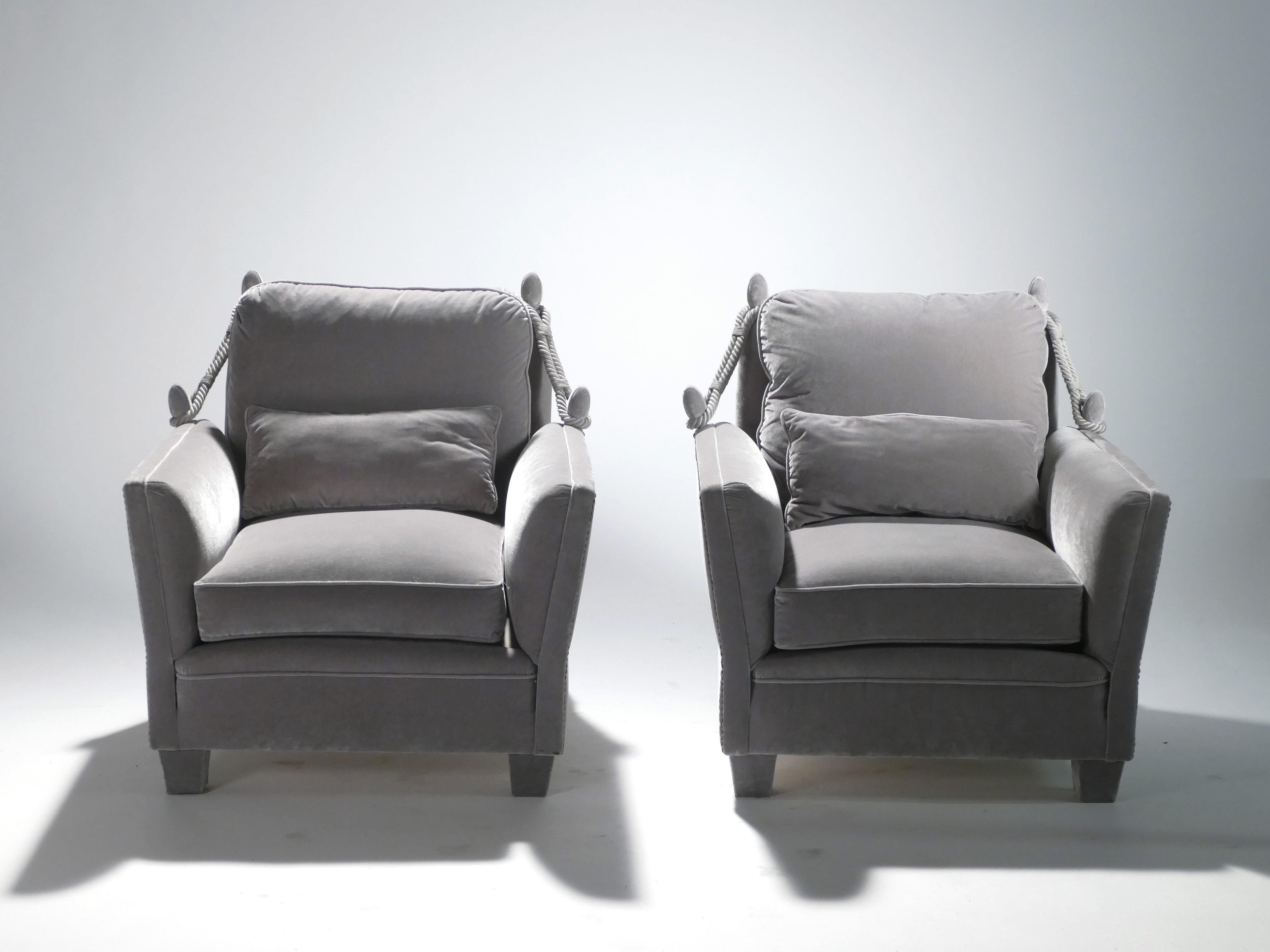 These chic, monochromatic armchairs feature their original, beautiful neoclassical structure, newly reupholstered in soft grey velvet Nobilis Quai de Seine. Passementerie details at either side give the pair an unmistakably French vintage appeal.