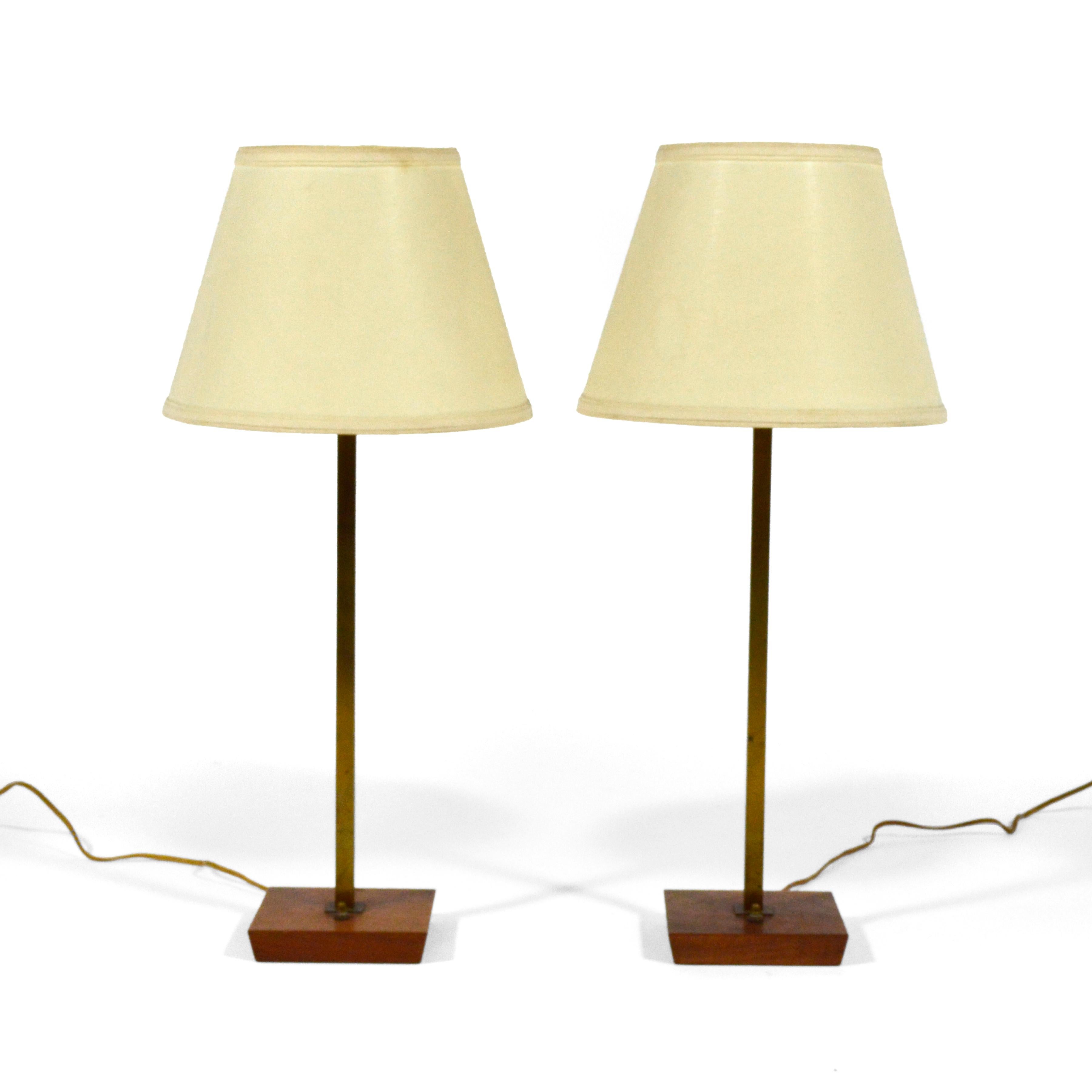 This lovely design with a walnut base supporting a neck of square stock brass has a refined simplicity reminiscent of Paul McCobb's work. The lamp has aquired a beautiful rich patina  from years of age and use.

Designated model N5958 the base is 6