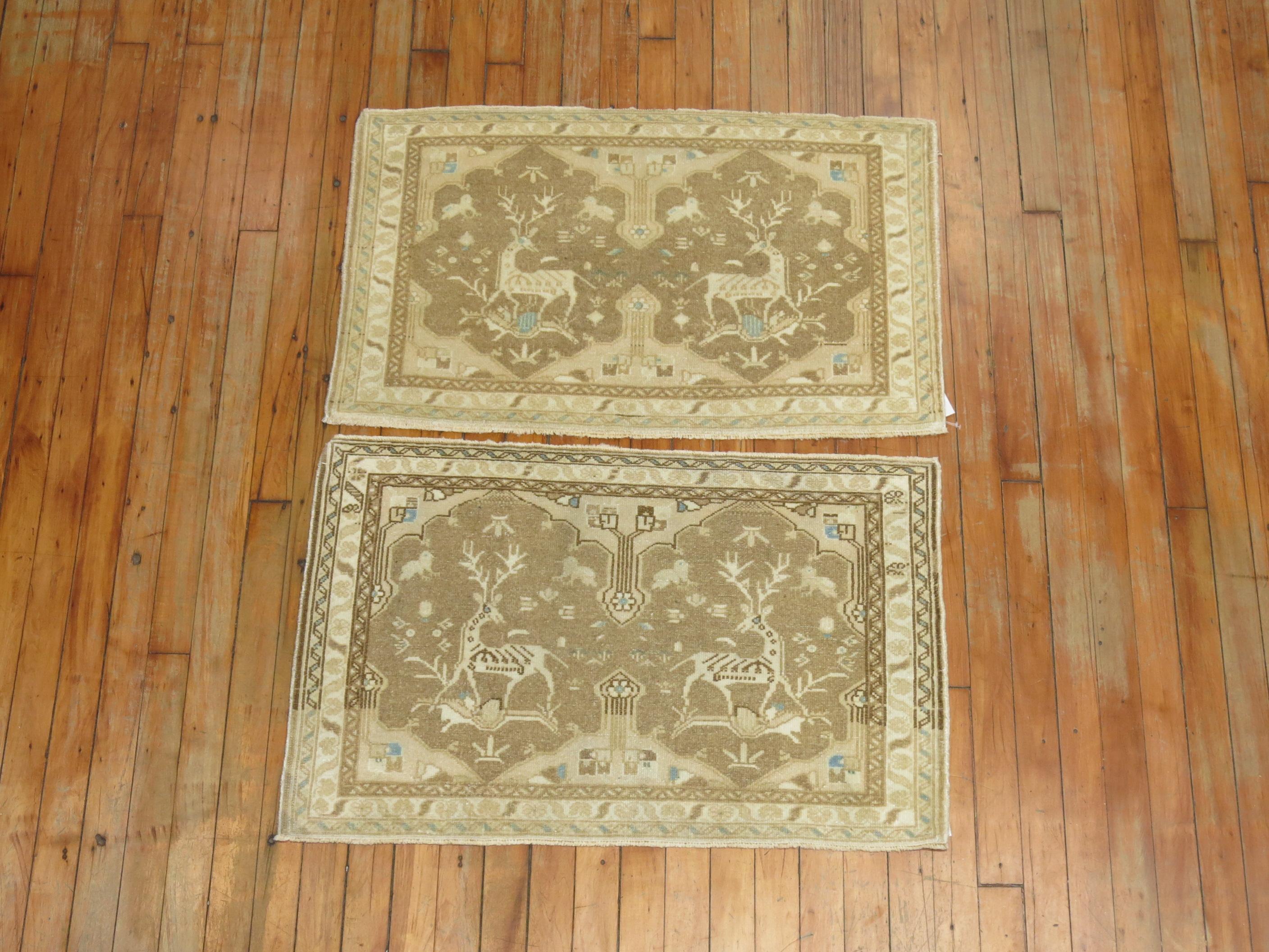 A pair of neutral Persian Tabriz rugs from the mid-20th century with a set of reindeer's staring at each other,

Measuring 21'' x 34'' respectively.
 