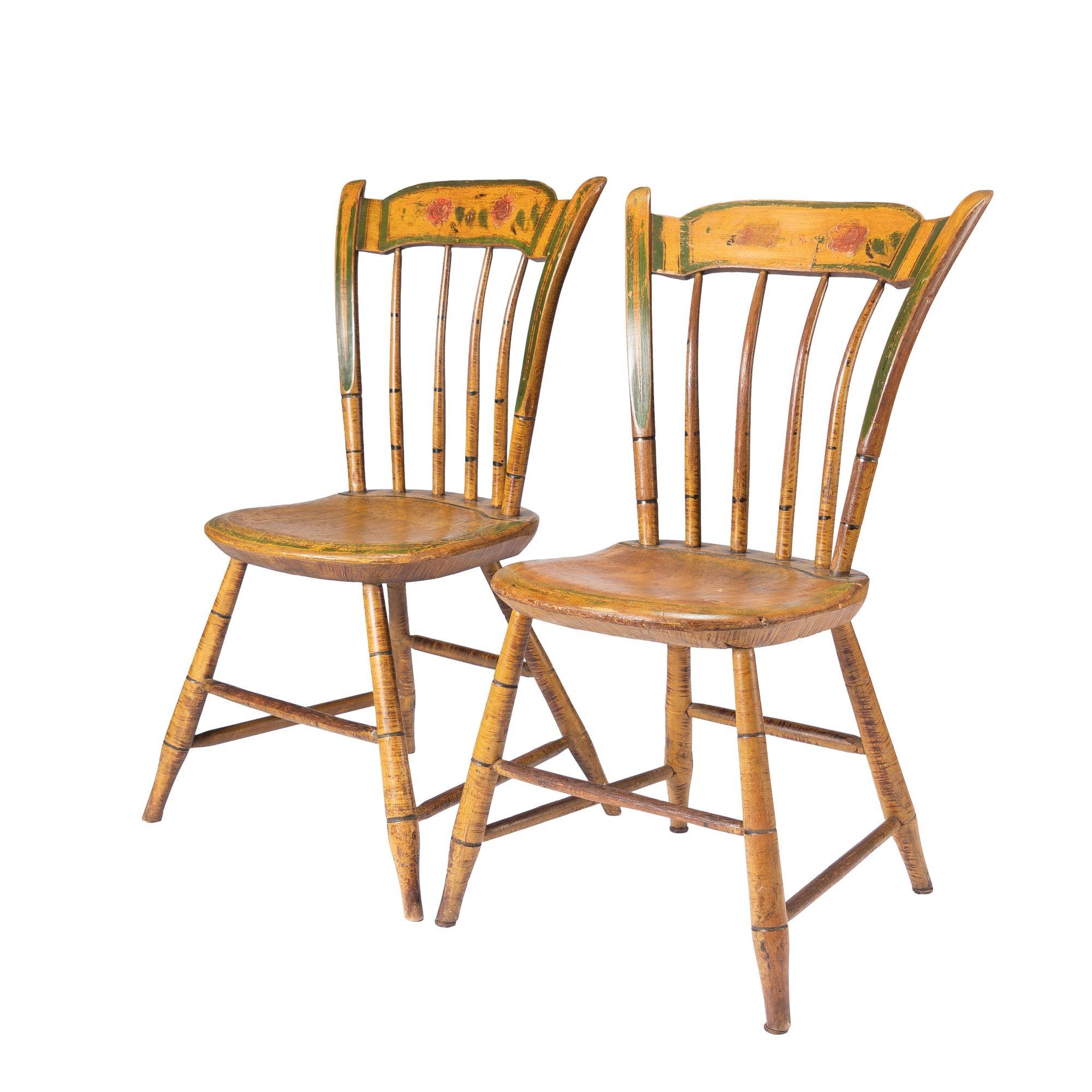 Pair of plank seat Windsor side chairs with thumb backs in their original paint decoration. The chairs are supported on four bamboo turned splayed legs joined by turned boxed stretchers. The spindle back supports a deep crest rail mortice between