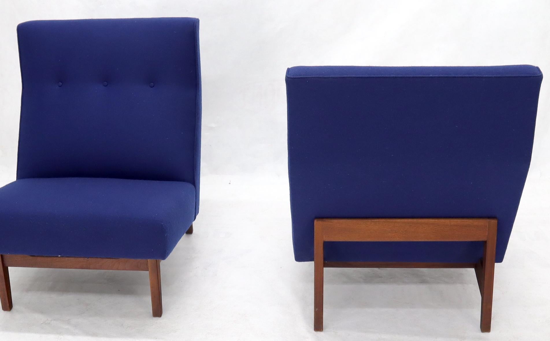 Pair of Classic Jens Risom lounge chairs in navy blue wool upholstery. Gorgeous oiled walnut frames.