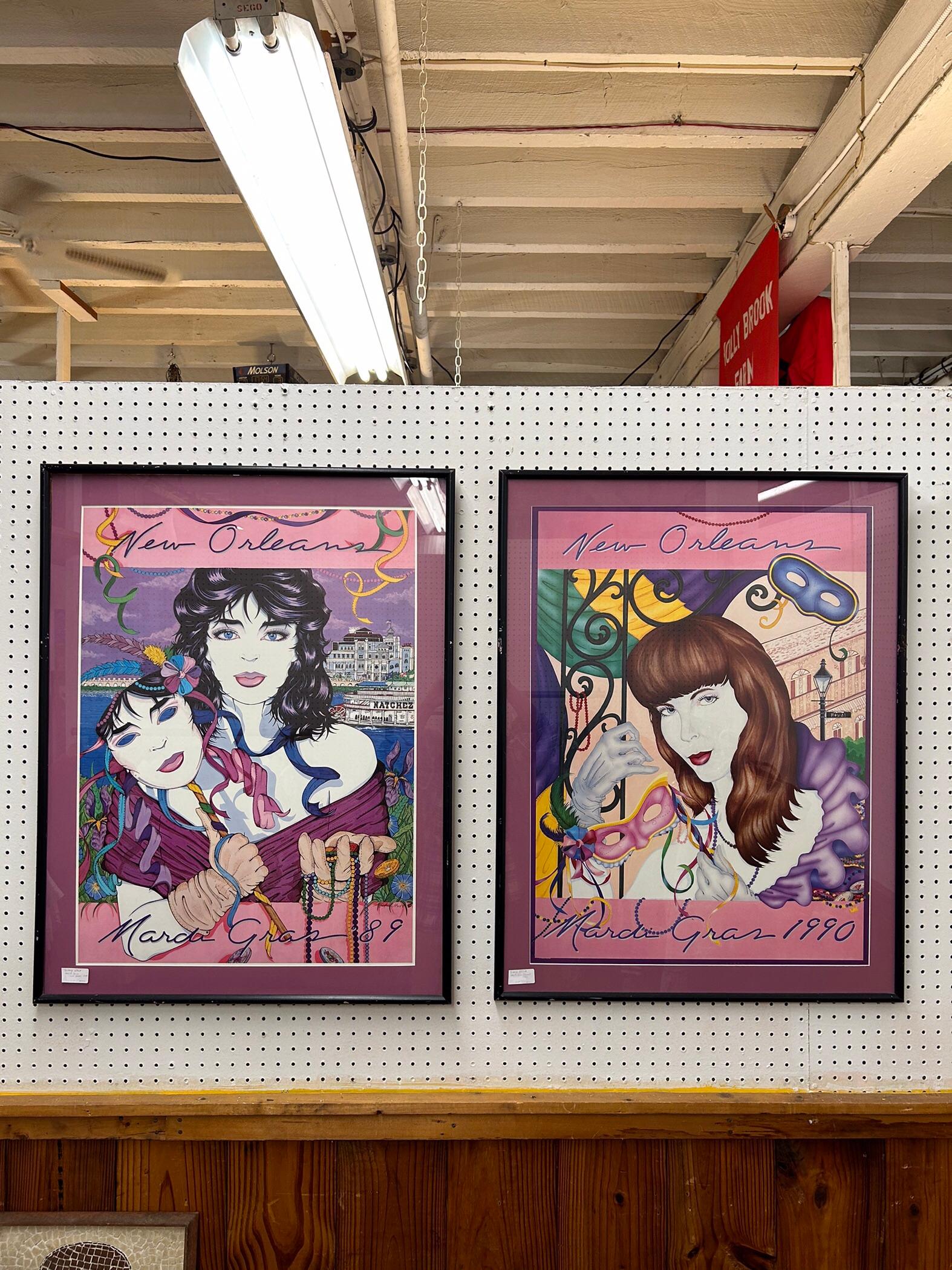 This pair of vintage New Orleans Jazz Festival posters circa 1989 & 1990 feature unique portraits of very 80s looking females, lots of Mardi Gras imagery, and black painted wood frames. 
Dimensions: 27.25w 1d 35.5h

Condition notes: Posters are in