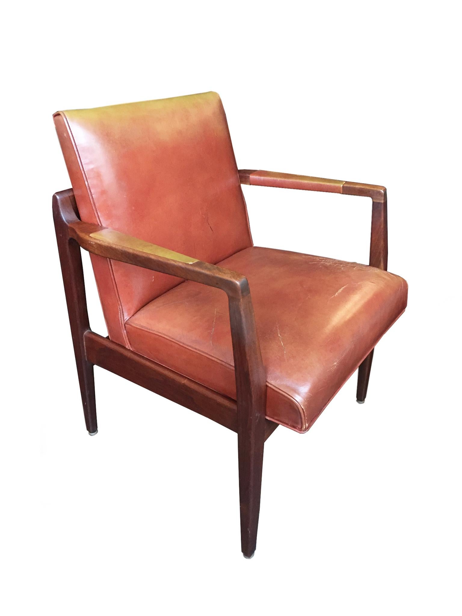 These two armchairs were designed and manufactured circa 1950s-1960s. They are crafted in the manner of the Danish American designer, Jens Risom, who infused American Modernism with elements of Scandinavian design. The chairs are comprised of a