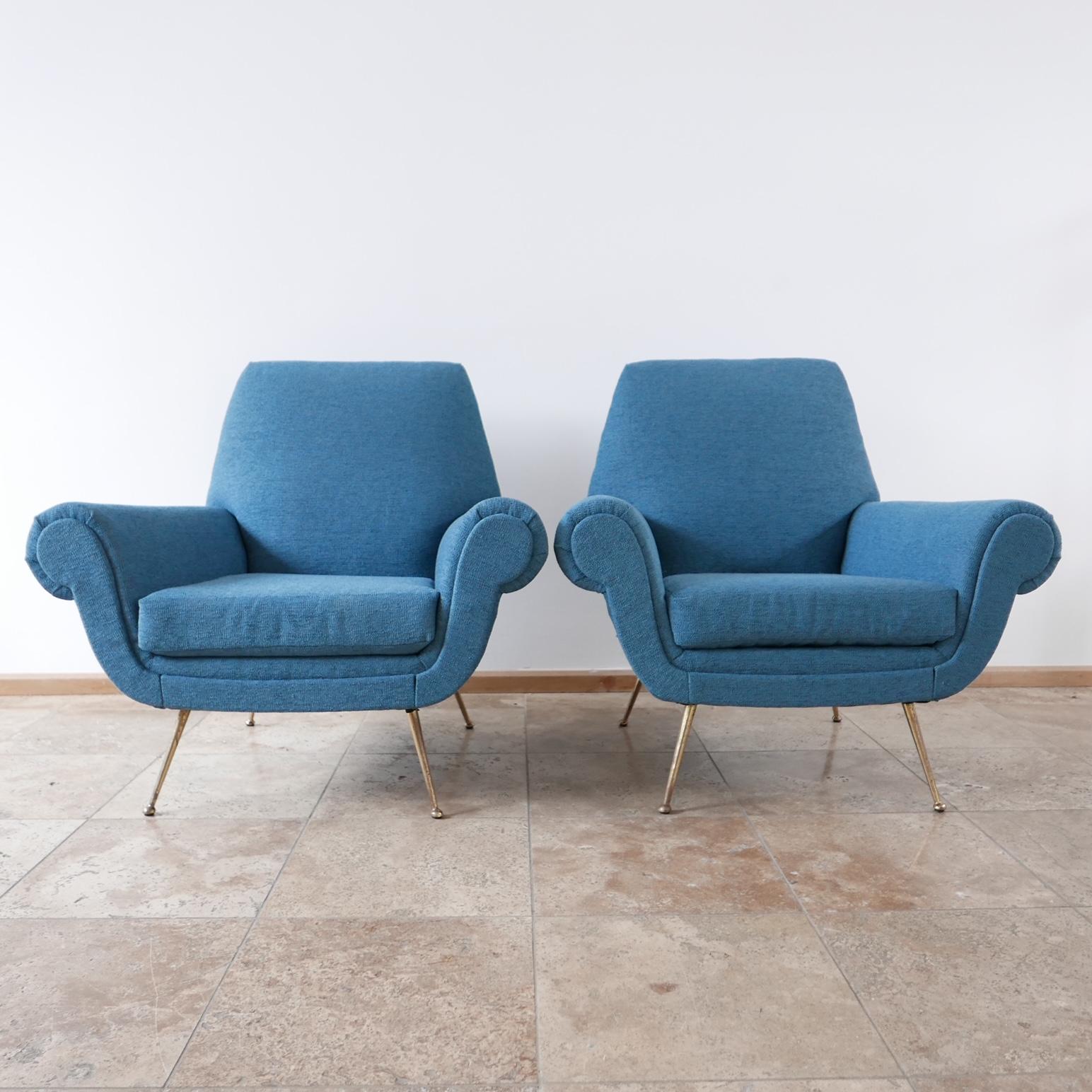 A pair of generous armchairs, newly upholstered in a blue fabric, raised over brass legs.

Italy, c1970s.

Comfy and timeless.

Price is for the pair.

Good vintage condition, scuffs and wear commensurate with age.

Location: London Gallery. 