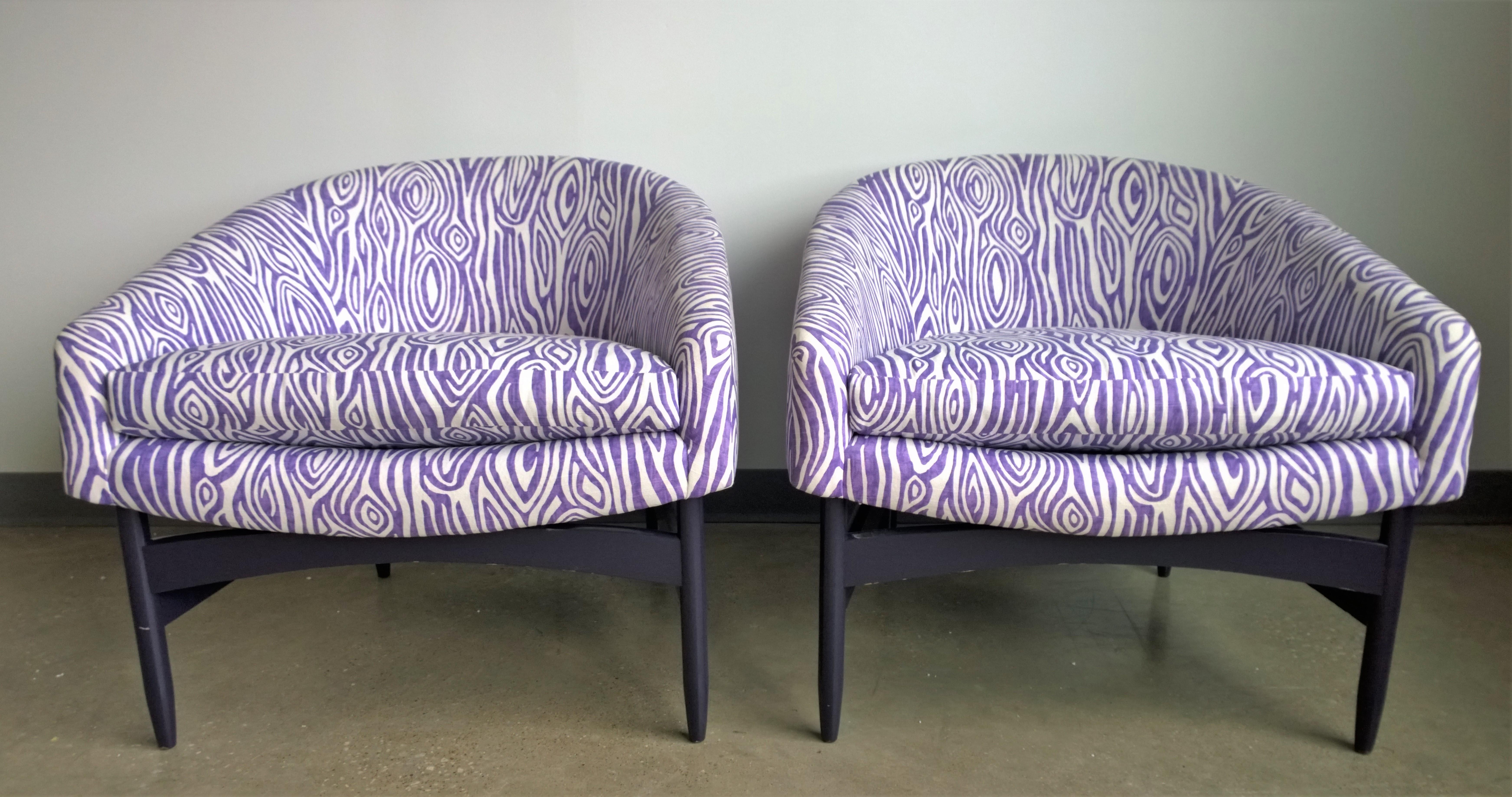 Offered is a pair of Mid-Century Modern Lawrence Peabody newly upholstered in purple and white animal print barrel back lounge chairs with newly lacquered wood frames. This pair features new faux bois pattern upholstery in electric orchid and white