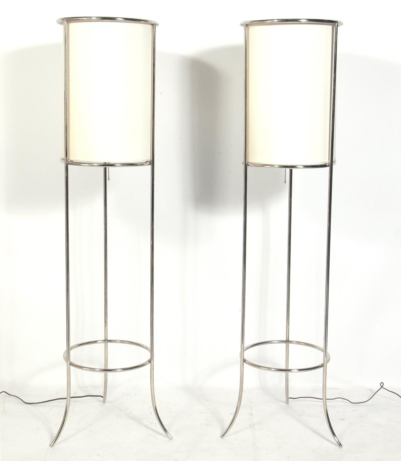 Pair of nickel floor lamps, attributed to T.H. Robsjohn-Gibbings for Hansen, unsigned, American, circa 1980s. They have been rewired and are ready to use.