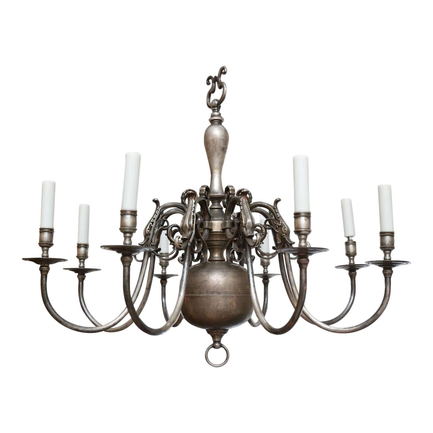 Pair of nickel on bronze Georgian style chandeliers (circa 1940s) with eight arms each. Candelabra-size sockets and newly wired for use within the USA. Wonderful color and natural patina. Includes chain and canopies. They are heavy and of