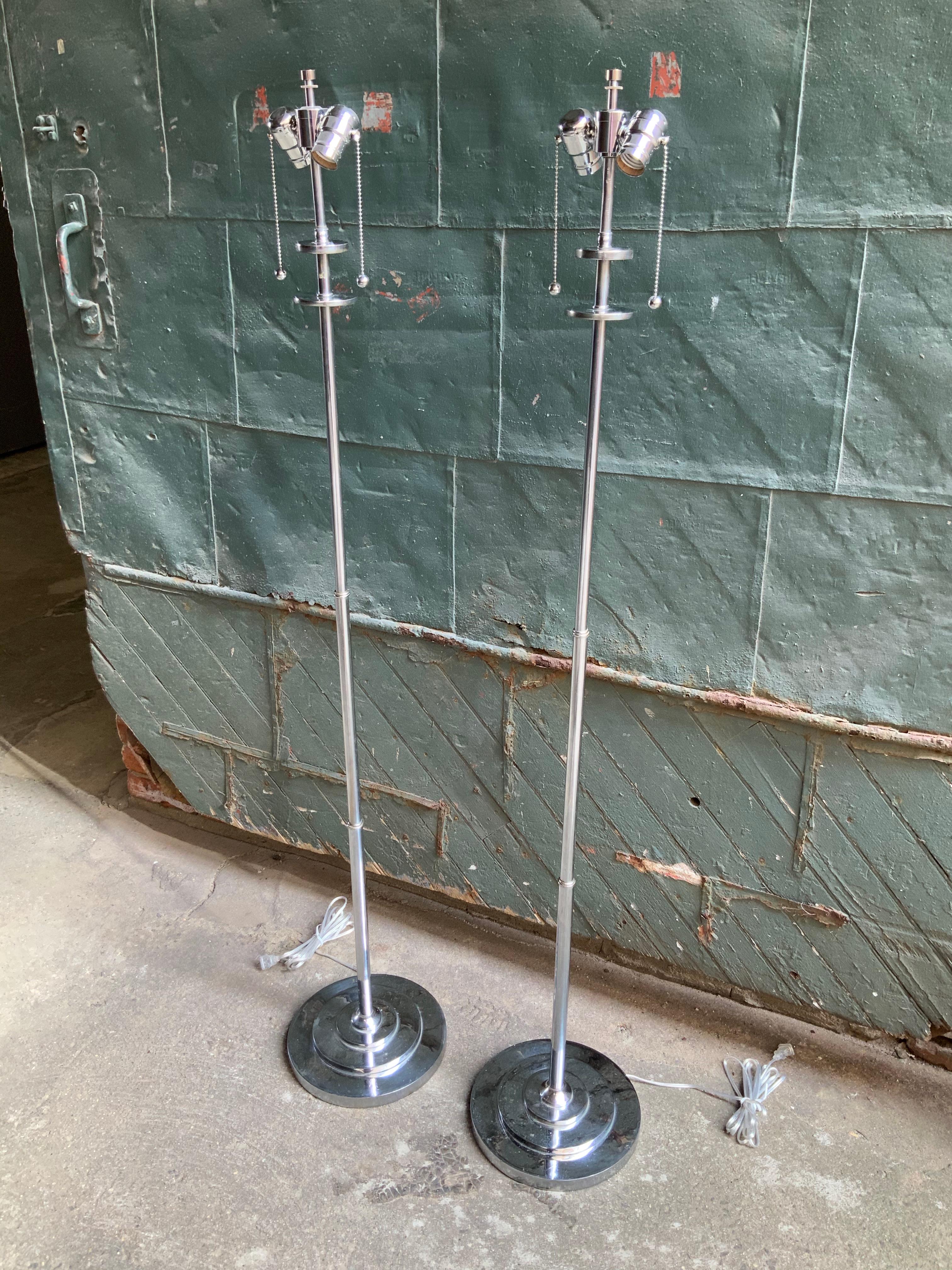 A wonderful pair of nickel plate Machine Age floor lamps, circa 1930-1935. Newly rewired and new bulb sockets. Minimalist design. Weighted base. Shades not included. Good overall condition with some light pitting to bases.

Measures: Approximately