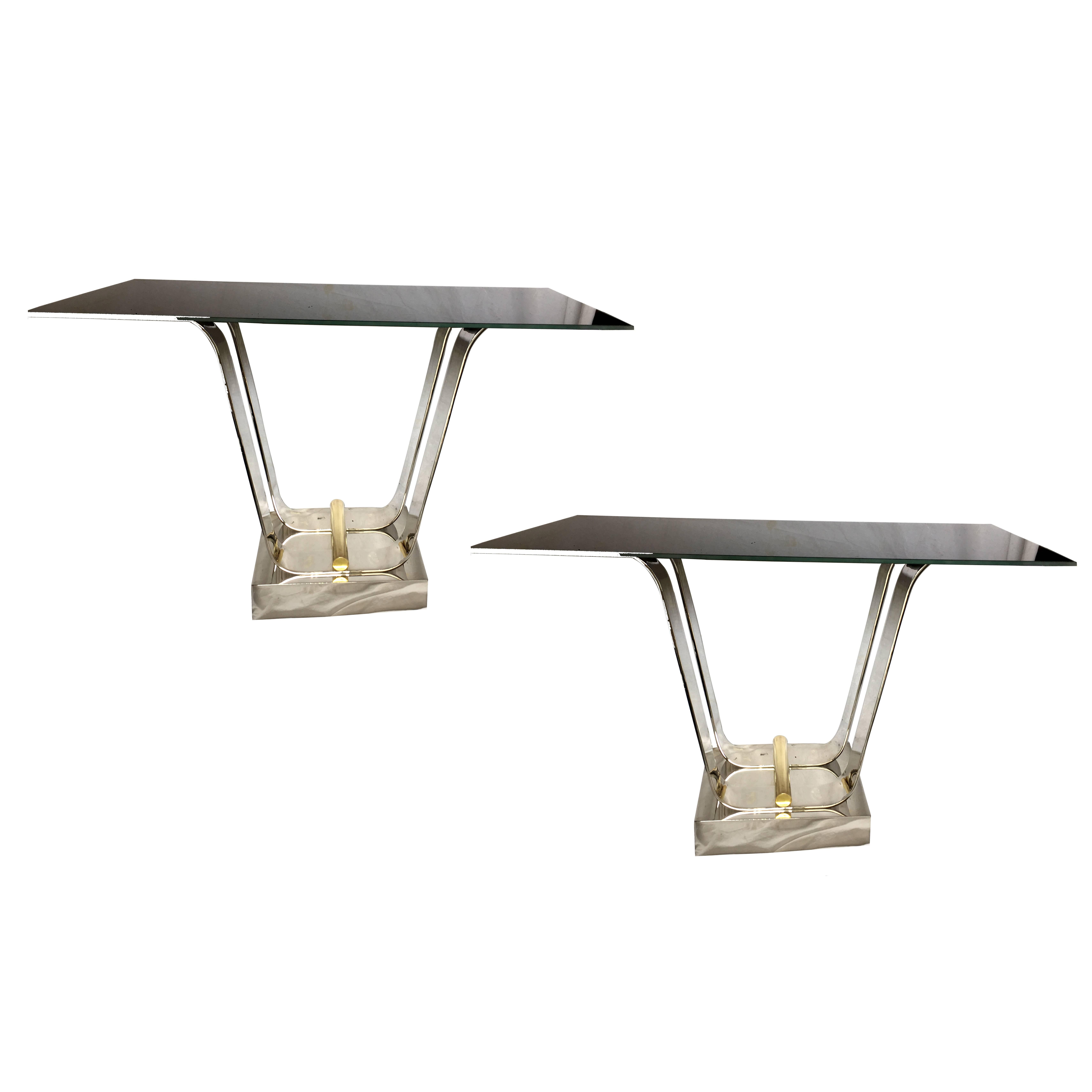 A pair of Italian, circa 1960s nickel-plated and bronze console tables, with black glass tops.
Sold as pair.

Measurements:
Height 32