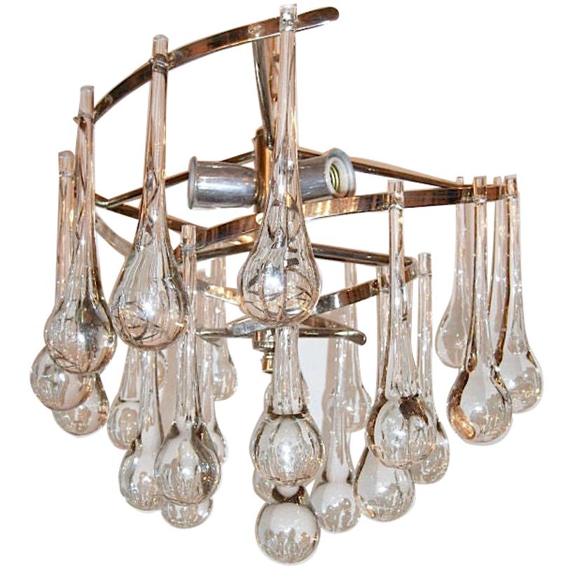 A pair of Italian circa 1950s flush-mounted nickel-plated light fixtures with oversized glass drops and with interior lights. Sold Individually. 

Measurements:
Diameter: 18