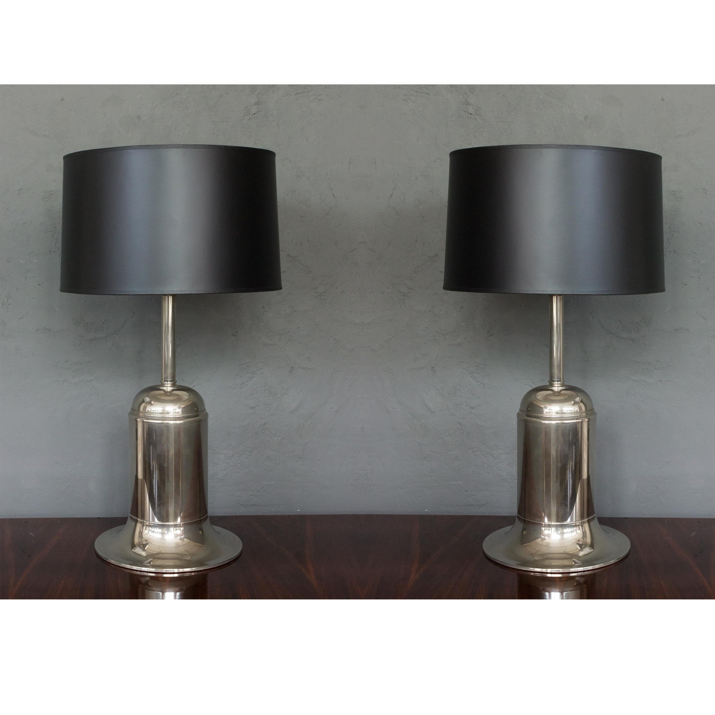 This sleek and modern pair of nickel-plated lamps hails from France in the 1970s. These lamps have recently undergone a meticulous polishing and rewiring, resulting in their excellent vintage condition. Standing at a height of 23 inches with bases