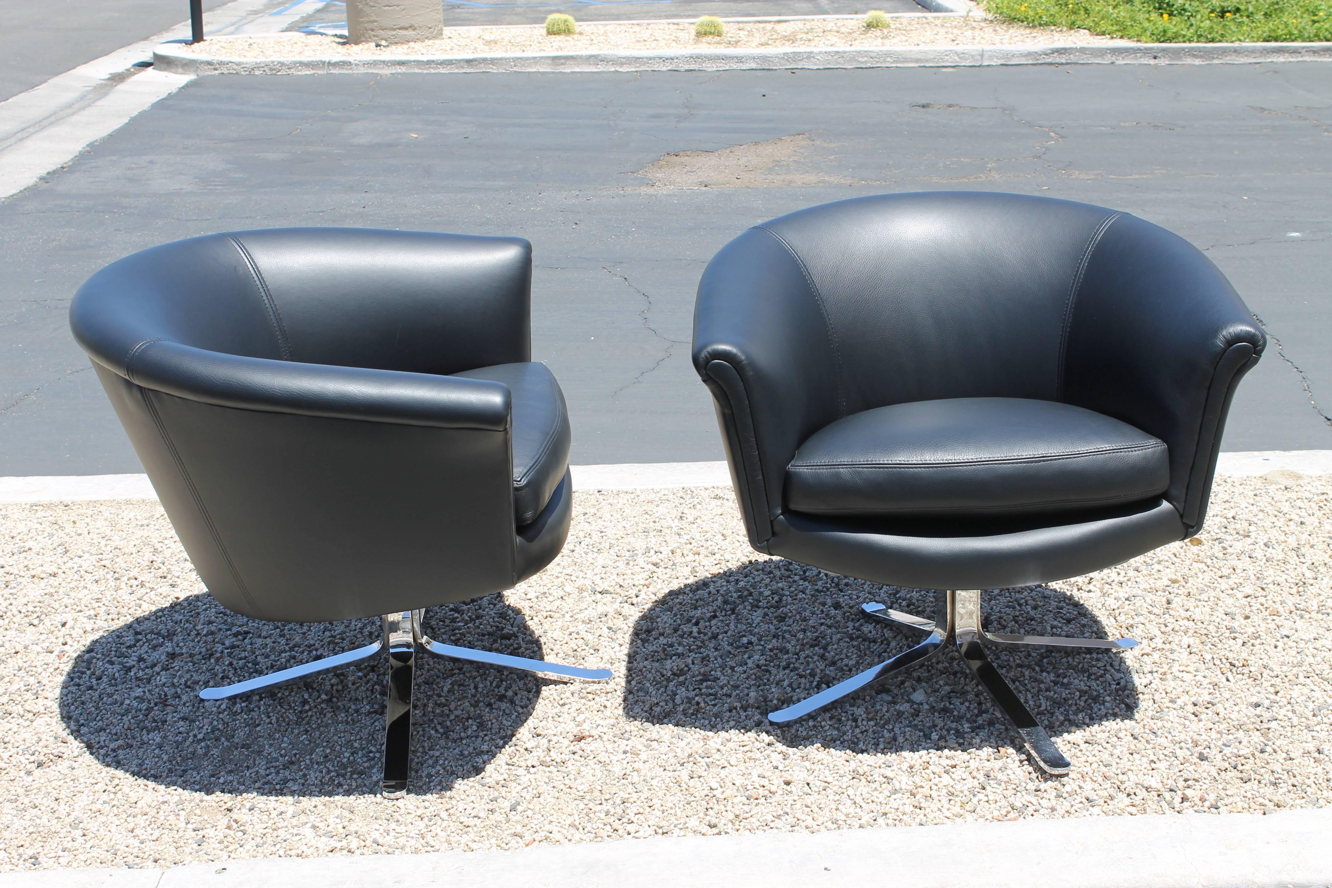 Pair of swivel or barrel lounge chairs by Nicos Zographos. Each chair measures 30