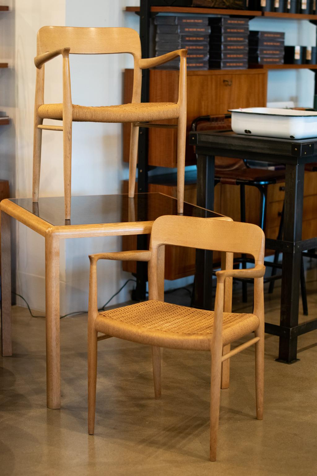 Pair of armchairs model 56 originally designed in 1954, in washed oak and Danish cord, by Niels Otto Møller for J. L. Møller, Denmark, 1950s-1960s.