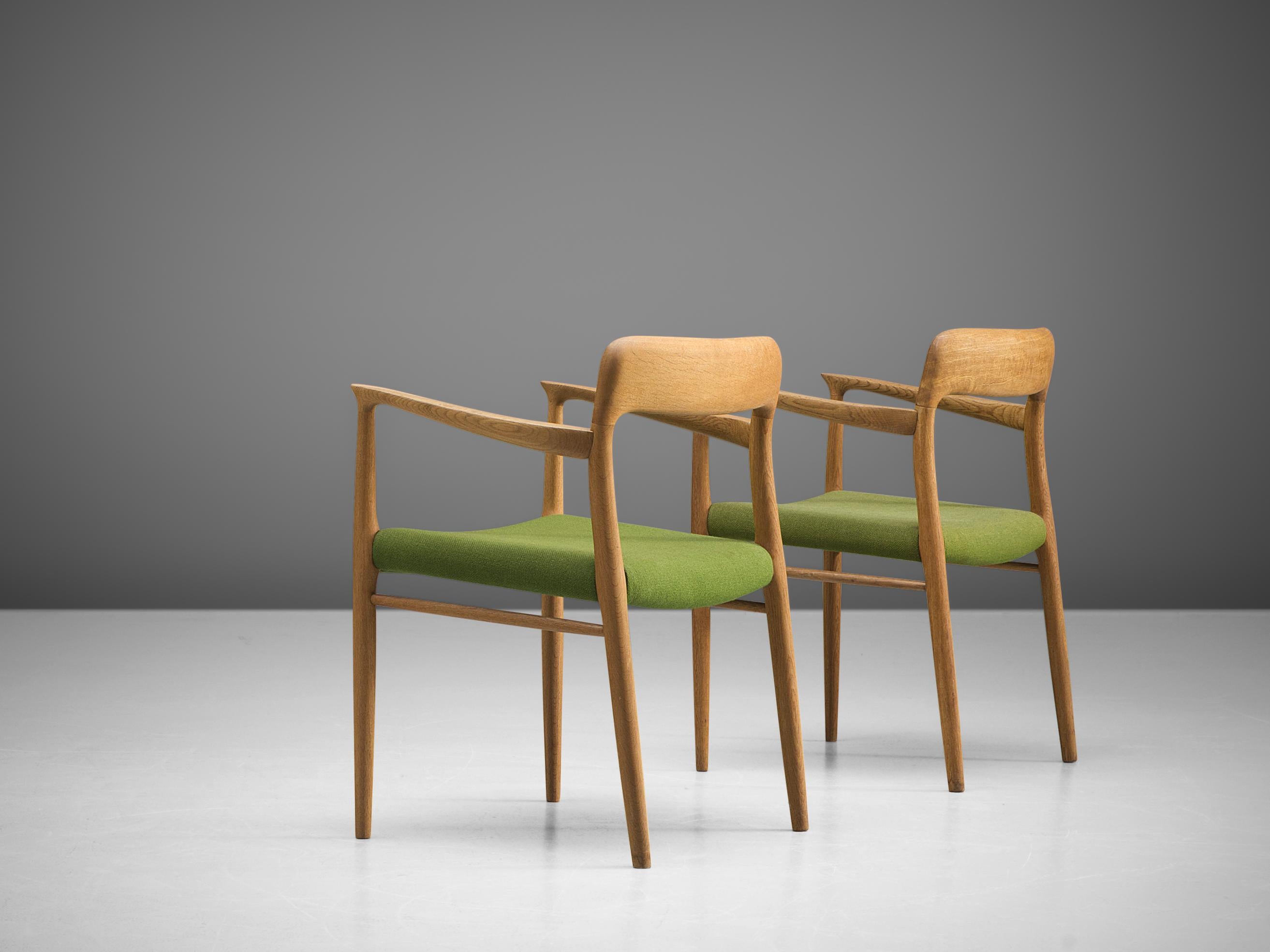 Niels Otto Møller for J. L. Møller, pair of chairs model '56', in oak and green fabric, Denmark, 1954. 
 
This chair shows subtle lines and beautiful curves of the woodwork. In the highly refined connections of the wood you can see the work of an
