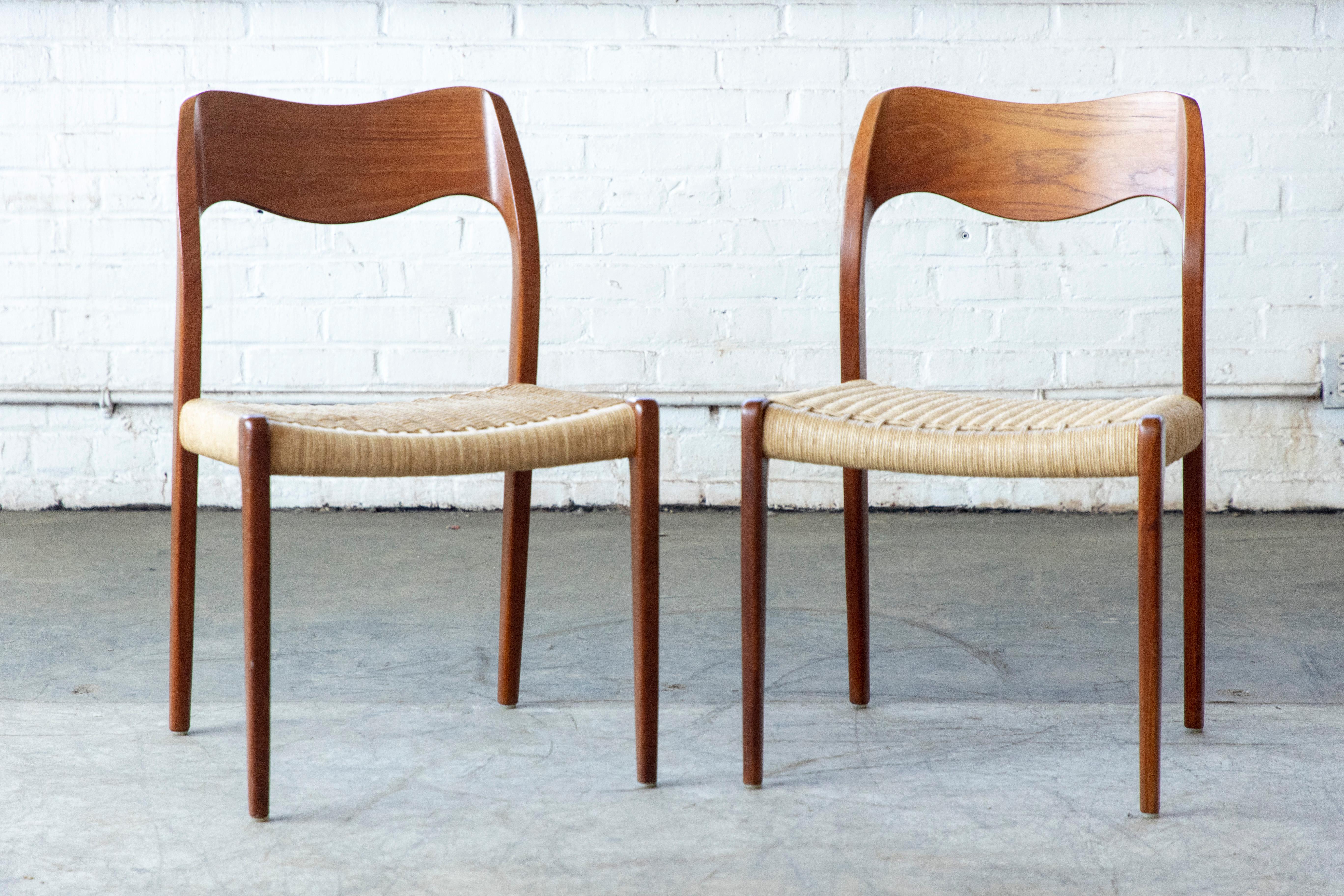 This pair of wonderful Danish modern teak armchairs Model 71 by NO Moller was designed in 1950's for J.L. Møllers Møbelfabrik. The chairs retain the original paper cord in very good condition. A truly classic midcentury Danish design to upgrade any