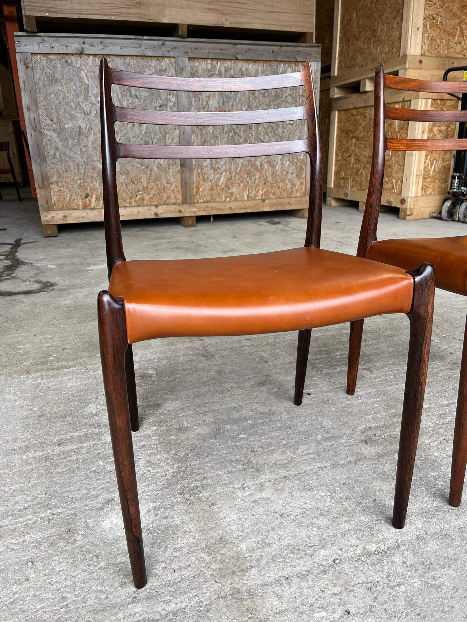 This pair of Niels Otto Moller's Model 62 dining chair was main in the 1960s as evidenced by the round labels. This pair has exceptionally beautifulk wood. The seats were reupholstered 10 years ago and now sold as seen with some scratches to the
