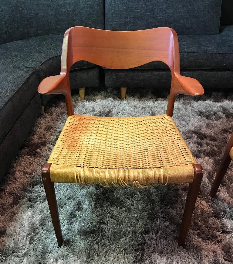 A wonderful pair of sculpturally designed armchairs by famed 20th century Danish designer Niels Otto Møller. Simple, yet elegant. Originally designed in 1951. This pair was produced in the 1960s and still retain the original cane, which need some