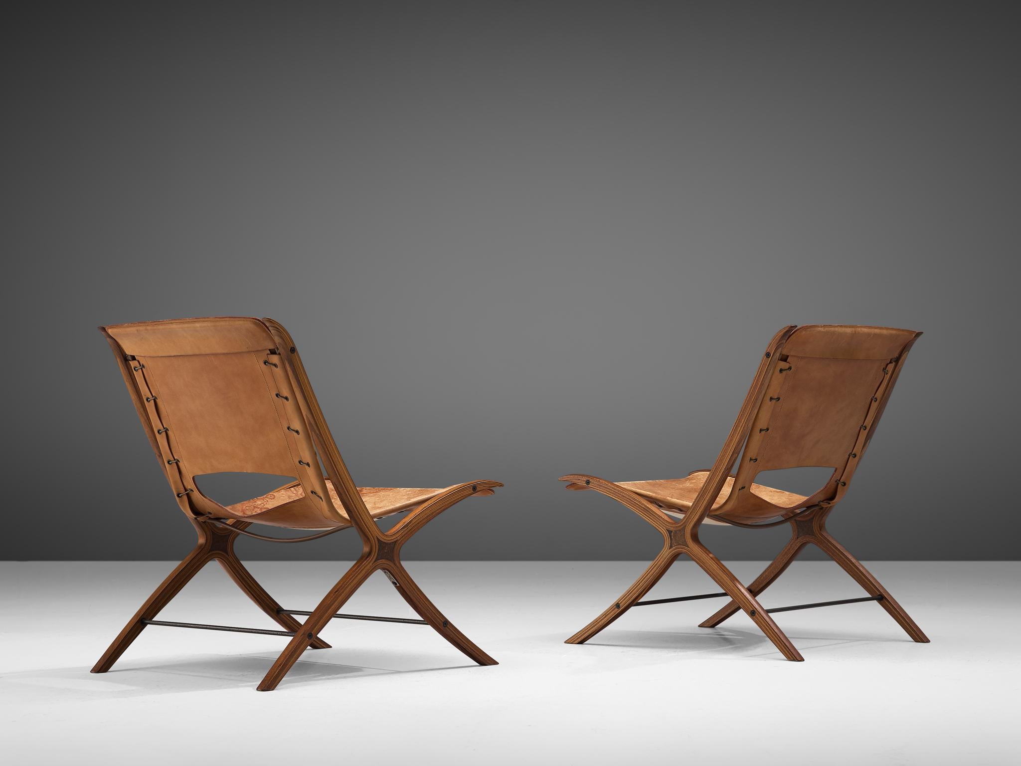 Peter Hvidt & Orla Mølgaard Nielsen for Fritz Hansen, pair of X-chairs 'model 6103', original cognac leather upholstery, mahogany and burl wood, Denmark, 1958.

This pair of chairs designed by Peter Hvidt and Orla Mølgaard Nielsen is for obvious