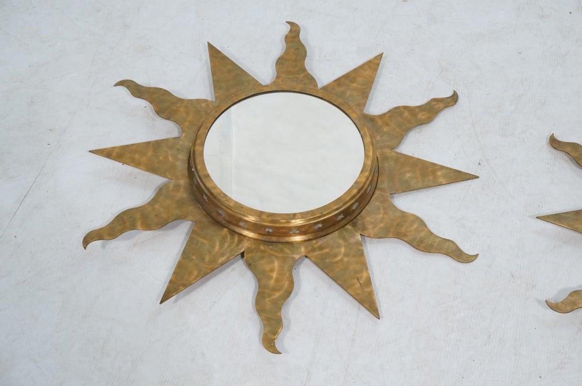 A pair of Niermann weeks bronze copper sun wall mirrors. Illuminating. American Studio handcrafted. Round mirror set in deep frame with faceted elements that light up. Can be wall or ceiling mounted. Marked on the back. 
Dimensions: H 32 inches x W