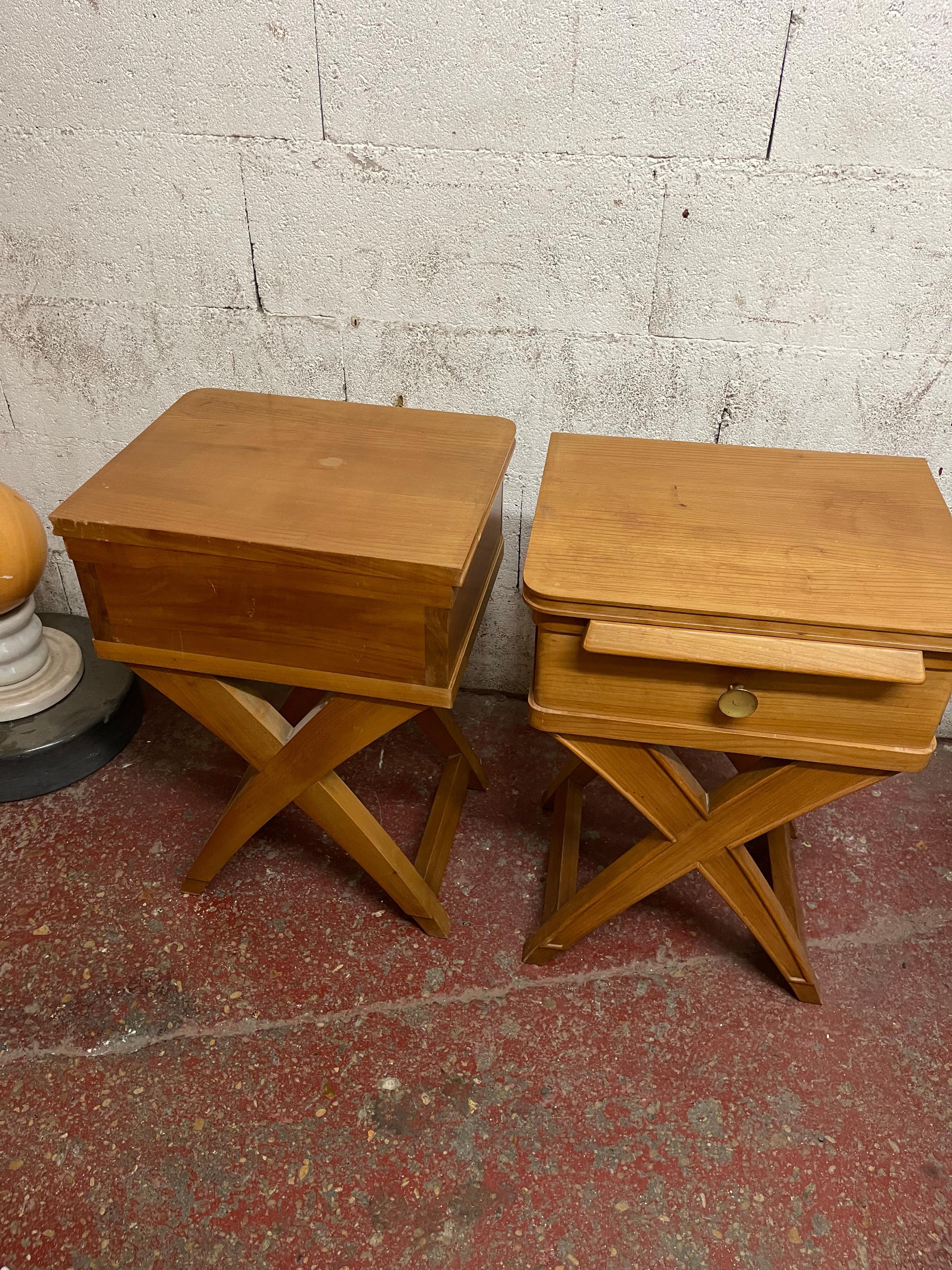 A pair of nightstand, circa 1940 in light wood with a cross base.