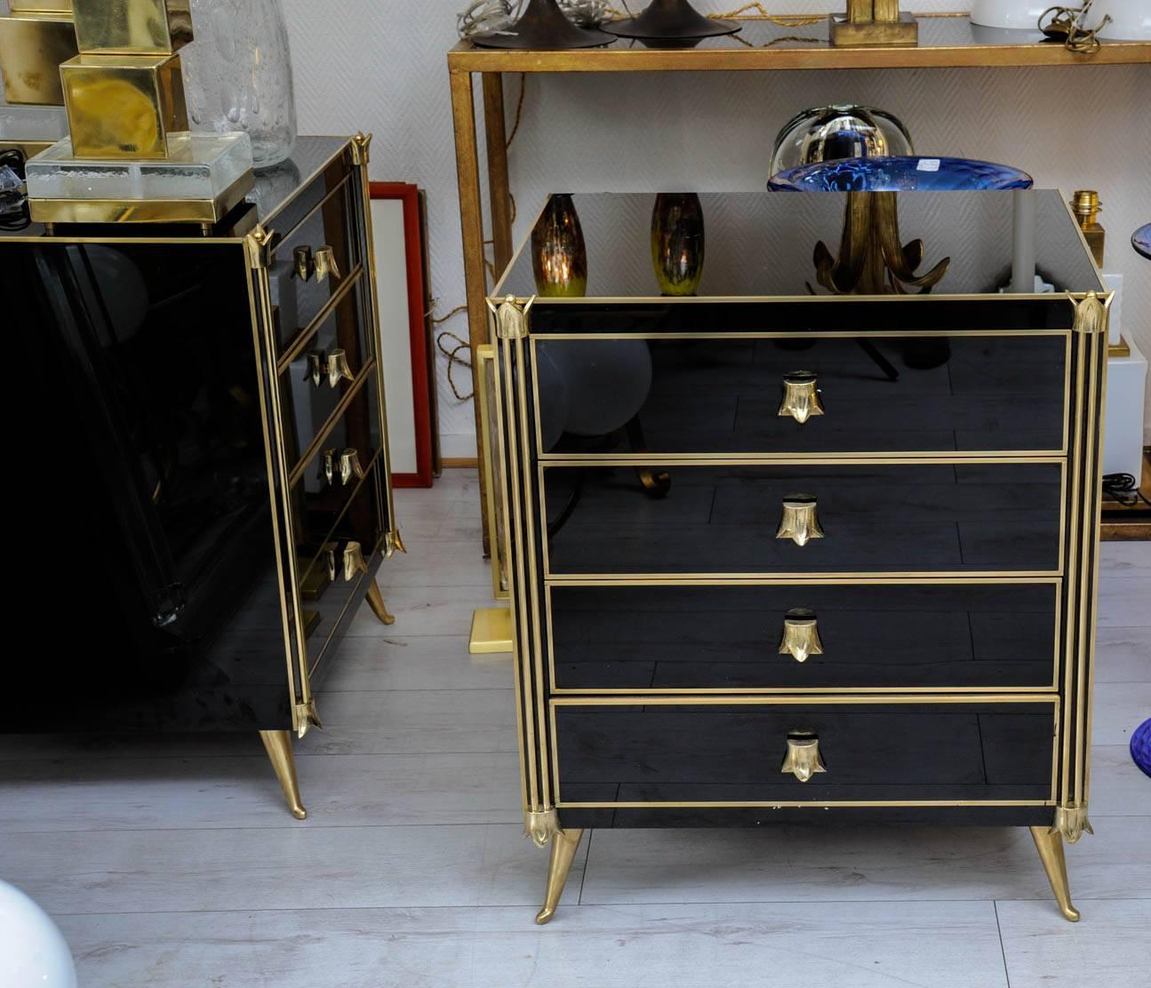 Pair of commodes or nightstands with four drawers in tinted black glass.