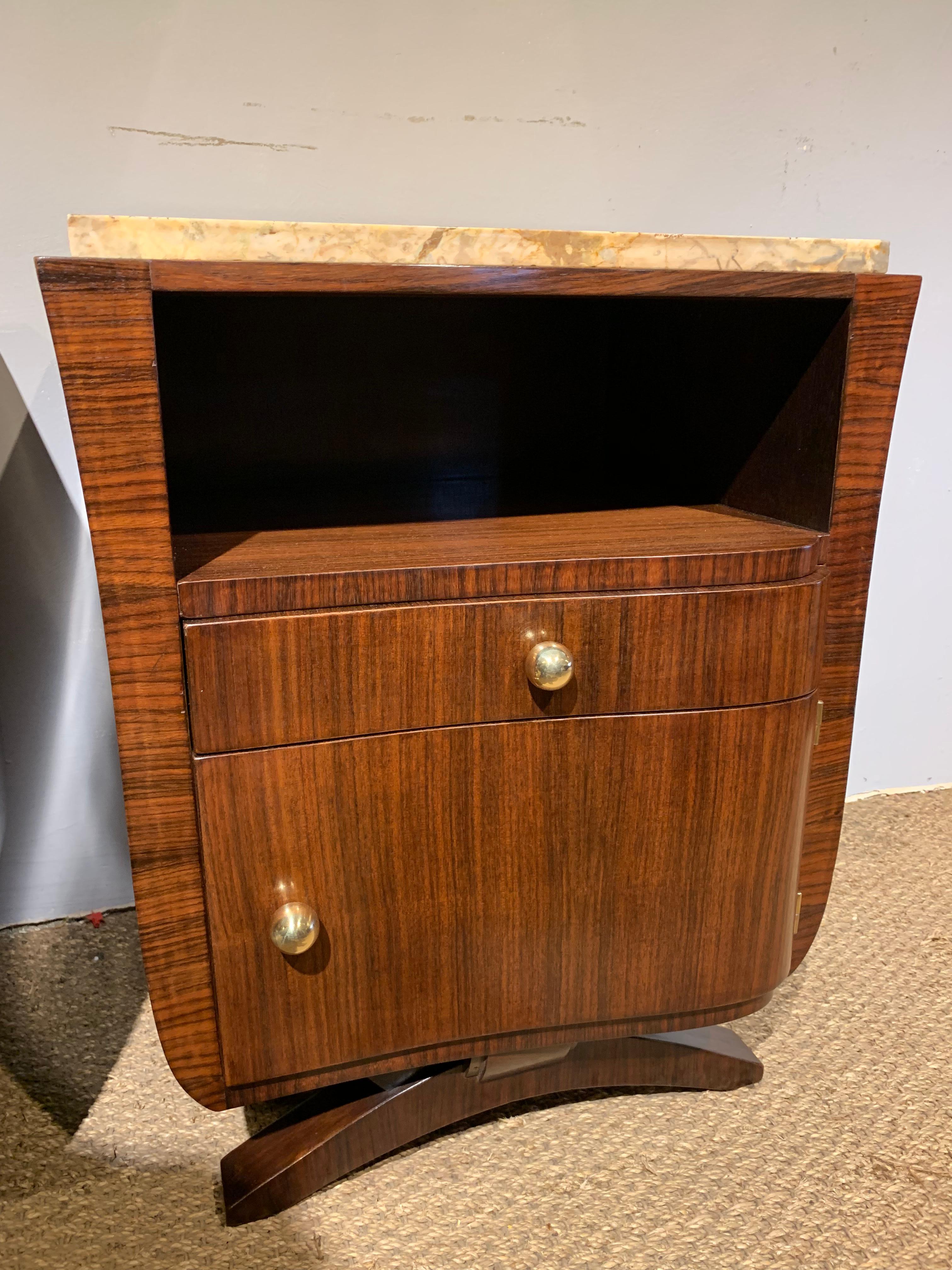 Great pair of Art Deco bedisde cabinets 

Dating to circa 1930s with original marble tops and brass knobs , Veneered with black walnut and the inside veneered with Satinwood , they have been through our workshops cleaned / polished and are ready