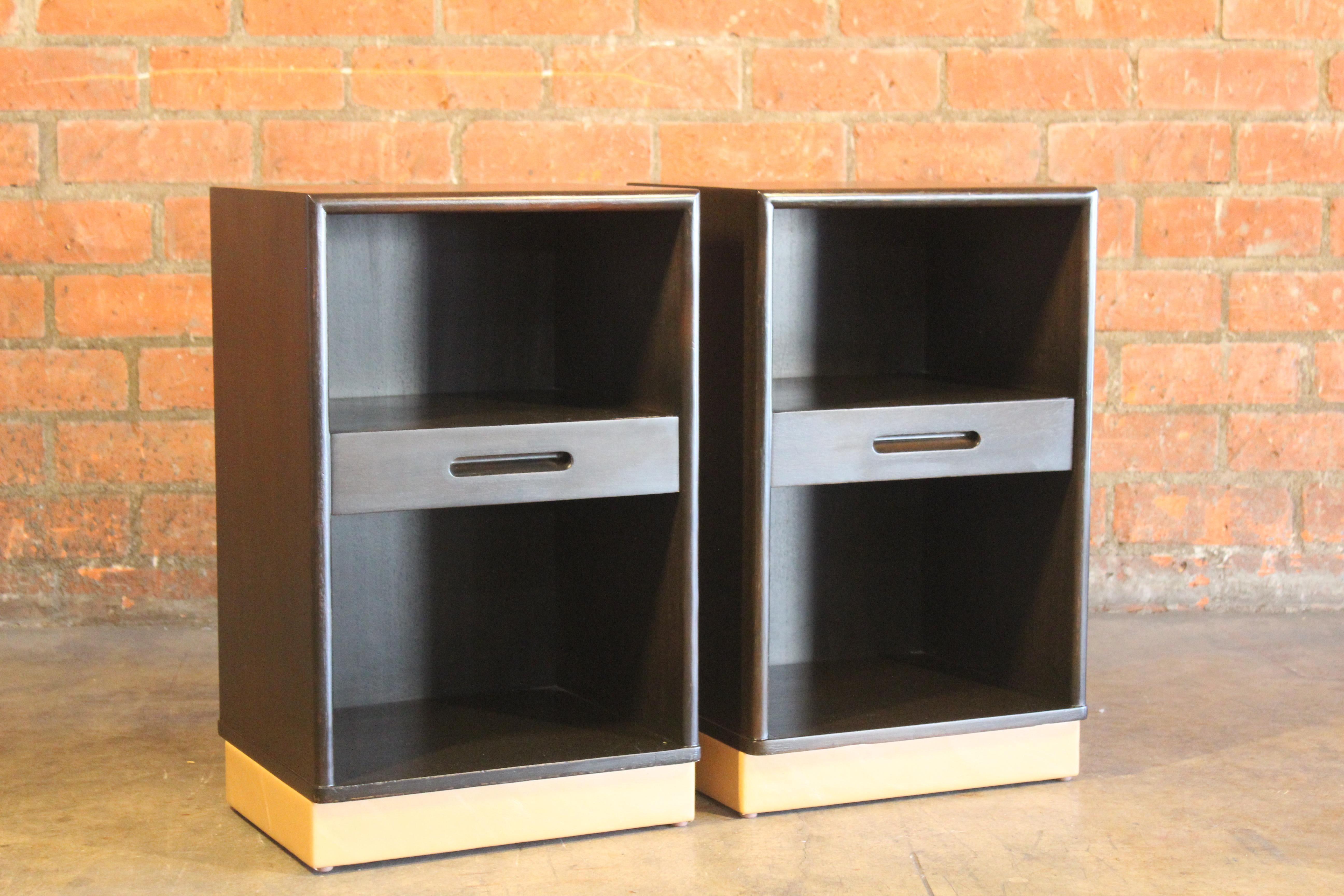 Pair of nightstands designed by Edward Wormley for Dunbar, 1950s. The pair have been restored and refinished and are in wonderful condition. New tan leather wrapped bases. Marked Dunbar on the backside.