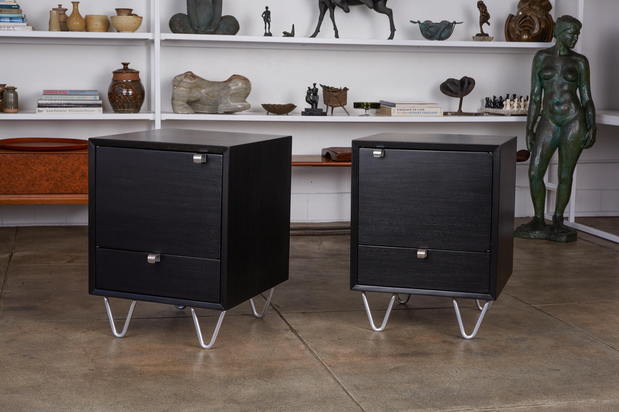 Pair of rare by George Nelson for Herman Miller Model 4617 nightstands, circa early 1950s. These Art Deco inspired pieces were part of Herman Miller’s Basic Cabinet Series. They feature short aluminum hairpin legs and curved aluminum pulls on an