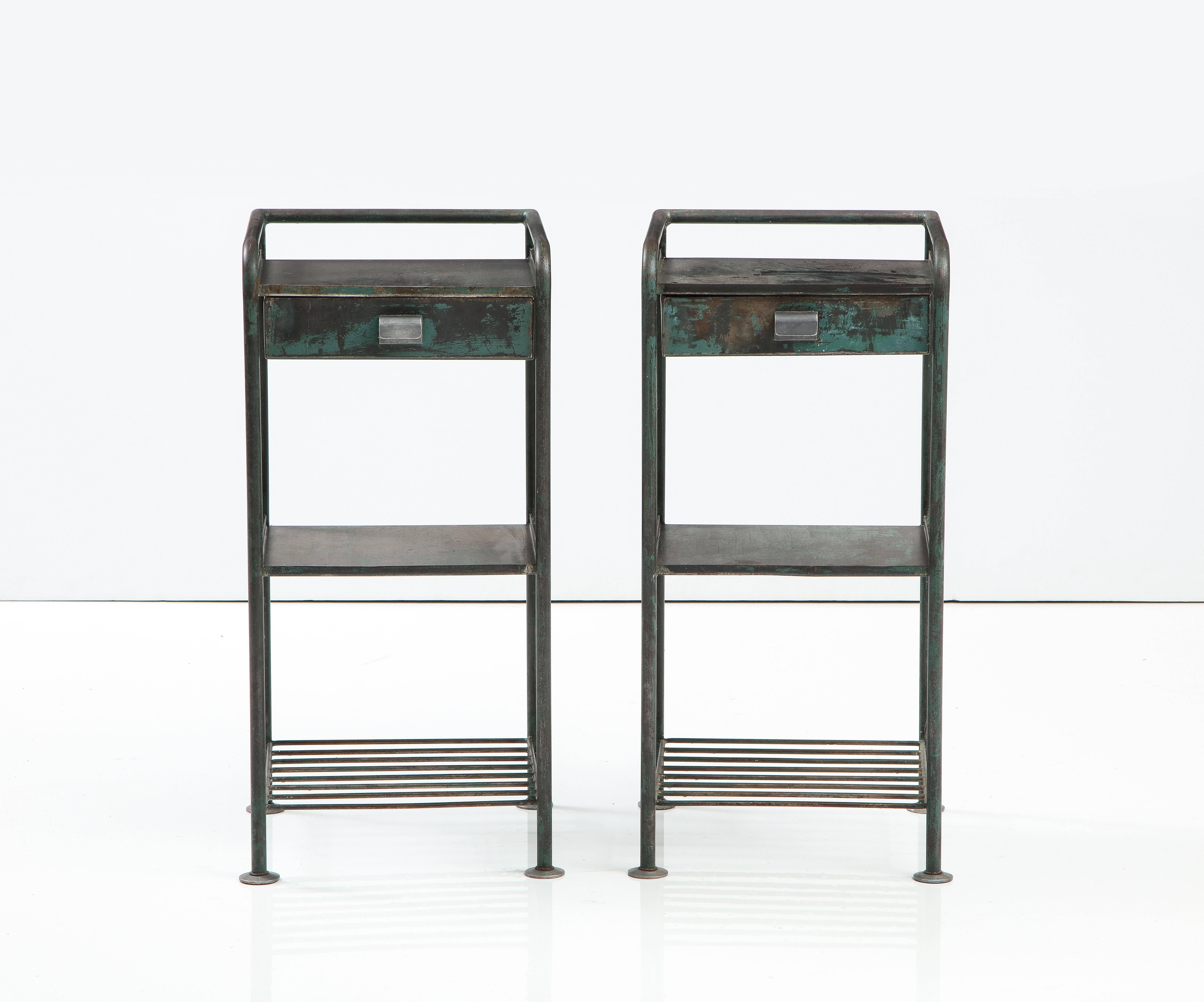 Pair of Nightstands by Jean Prouvé, France, c. 1935-1936. 

Originally designed for the Lycée de Metz in France, these quintessentially Prouvé nightstands consists of clean tubular steel frames, two levels of tiered shelving, and a single drawer