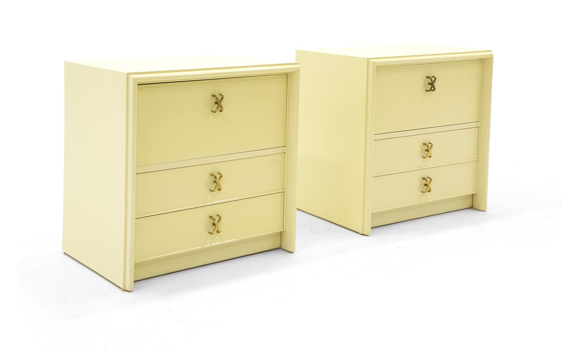Pair of nightstands / side tables designed by the most important American Art Deco furniture designer, Paul Frankl, for Johnson Furniture Company and sold by John Stuart Inc, New York. Signed with the branded Johnson Furniture logo and metal John