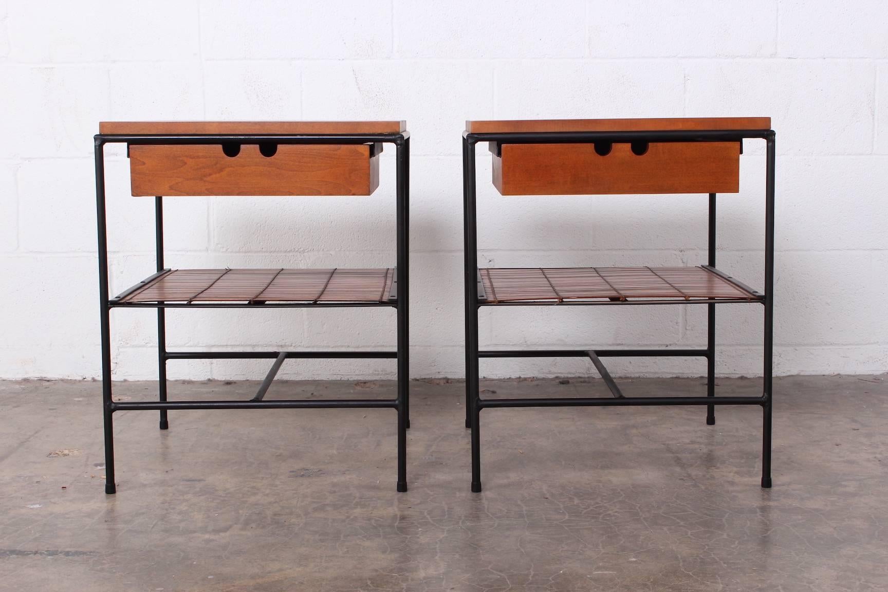 A pair of iron framed nightstands with bamboo shelf. Designed by Paul McCobb for Winchendon.