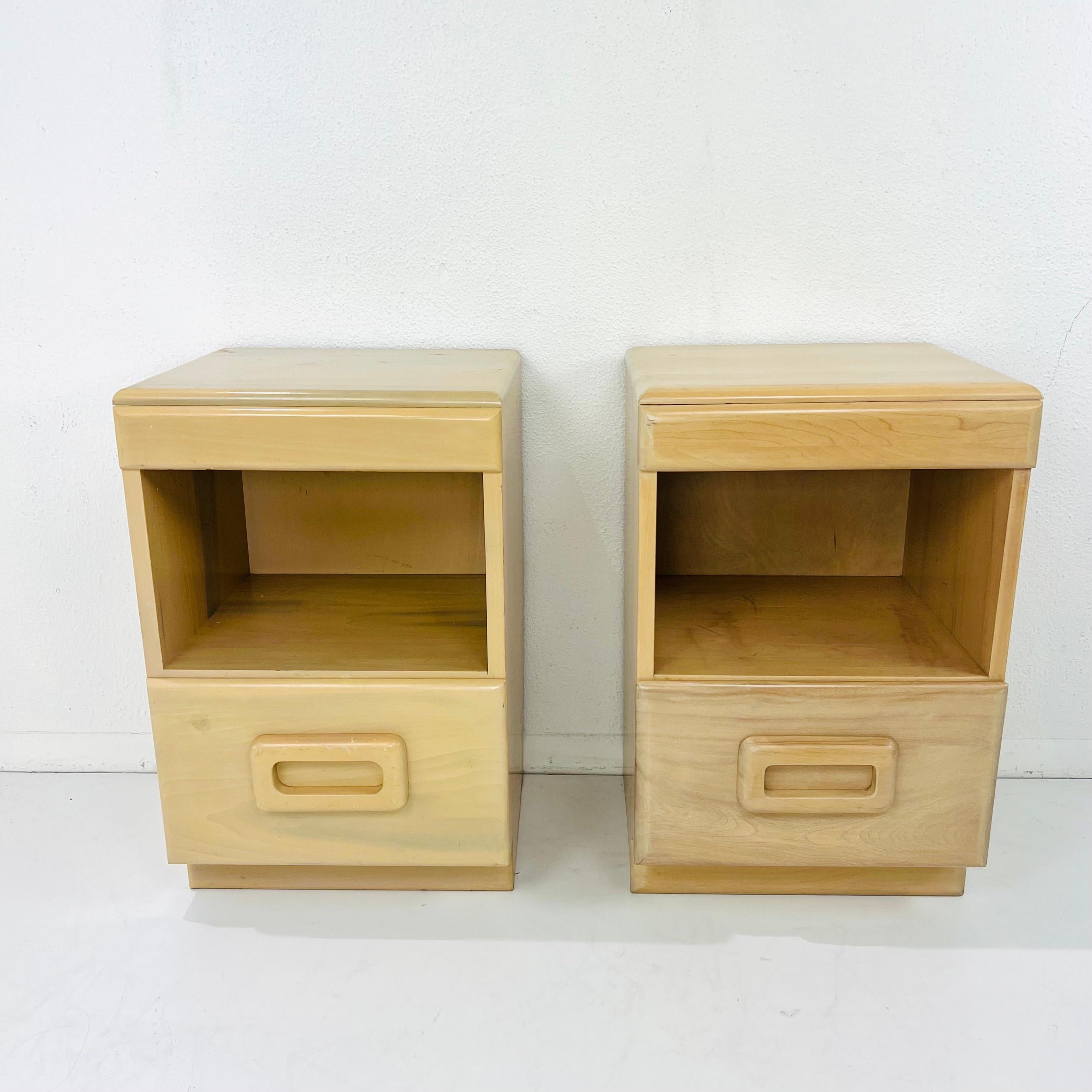 Iconic pair of early 20th century American modernist nightstands featuring drawers with wooden pulls and dovetail joints, designed by Russel Wright for Conant Ball, circa 1940. Beginning in the late 1920s through the 1960s, Russel Wright created a