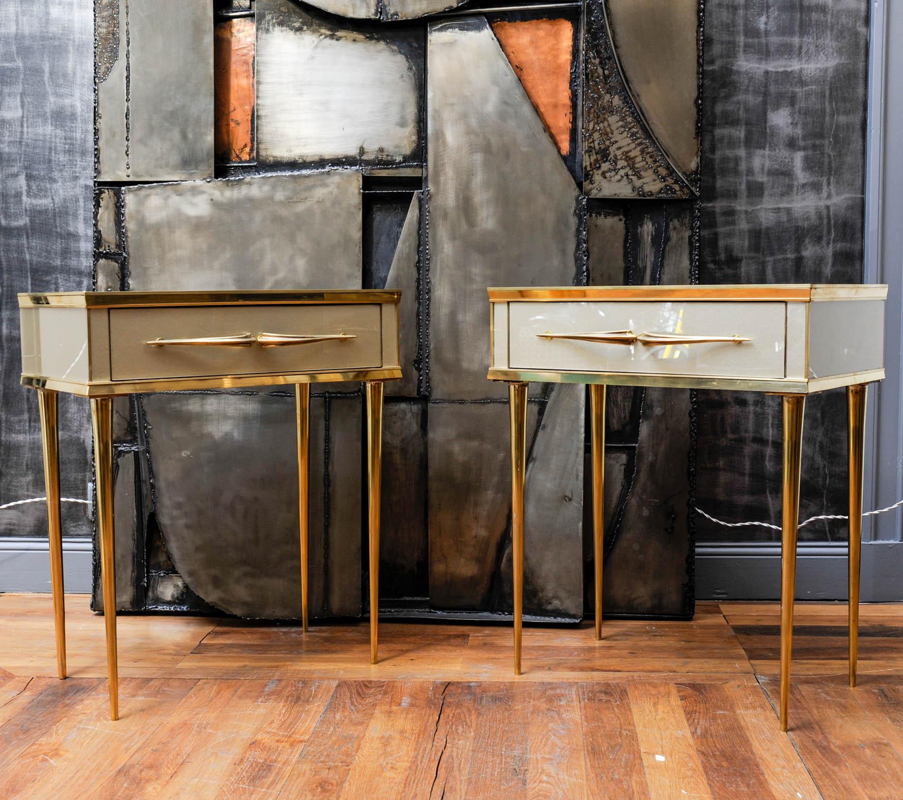 This pretty pair of nightstands have been created by Studio Glustin. Made of wood covered with Murano glass, feet and handles of the drawer are made of brass fillet.