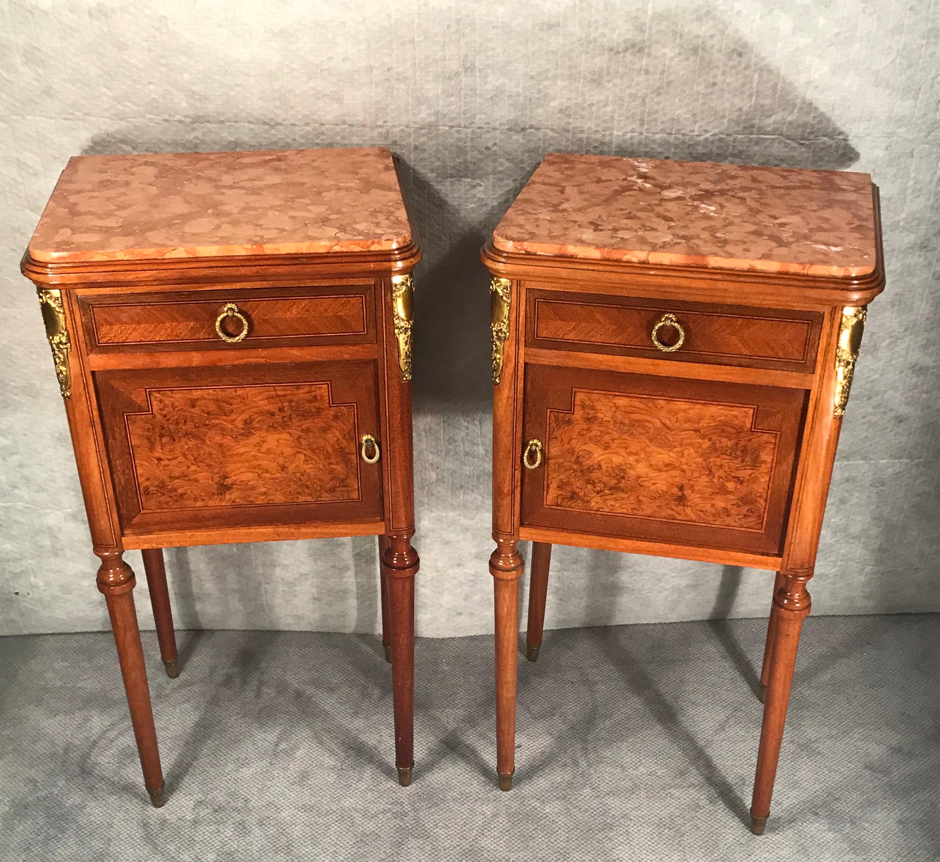 Pair of nightstands in the early Art Nouveau style from France.
The very decorative nightstands date back to around 1890-1900. They are embellished with maple and mahogany veneer. The design still shows some influence from the earlier Napoleon III
