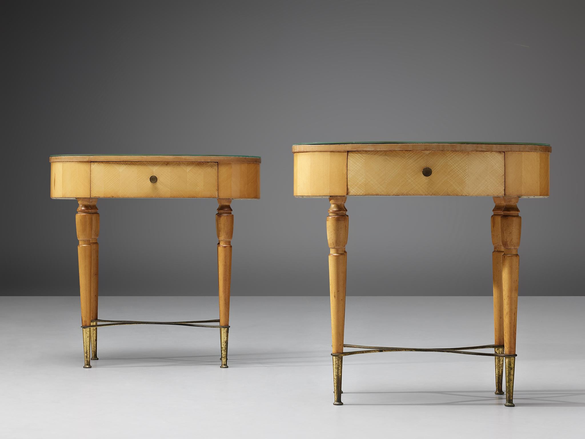 Pair of nightstands, beech, brass, glass, Italy, 1940s

These two nightstands show pure elegance. On brass feet the refined shaped legs evolve to the oval top with one drawer. The glass tabletop is colored green, the bright wood in combination