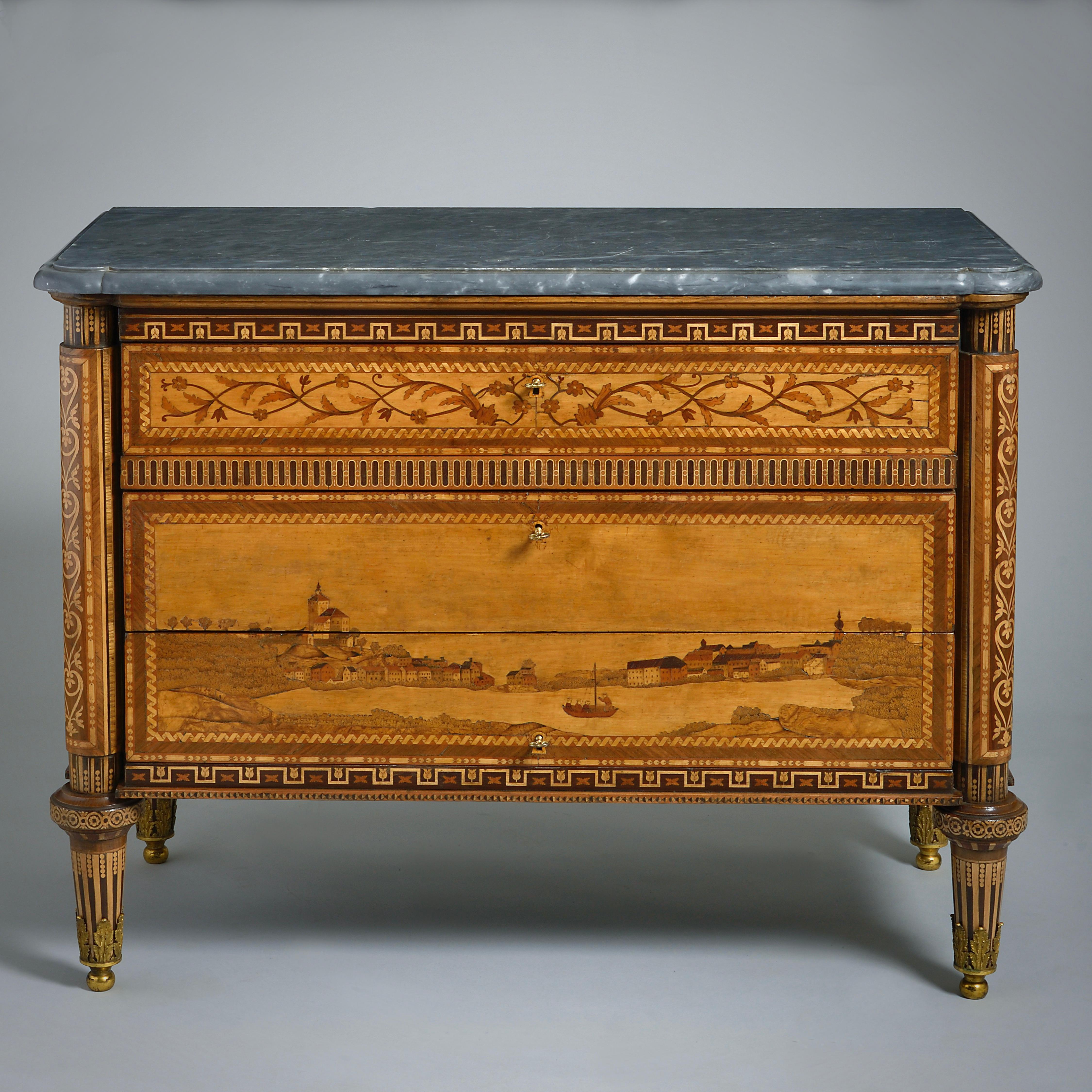 An exceptional pair of Russian panoramic marquetry commodes by Nikifor Vasilyev, St. Petersburg, circa 1780.

Each with it’s original eared and moulded bardiglio marble top. The front and sides elaborately inlaid in various woods including