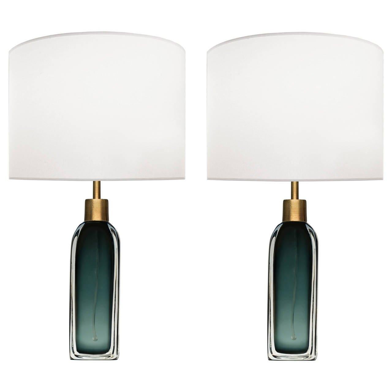 A pair of green glass lamps with thick clear glass casing and brass hardware by Nils Landberg for Orrefors.

Swedish, Circa 1950's

Lamp Shades Are Not Included.

If you are interested in Lamp Shades, please email The Craig Van Den Brulle Design