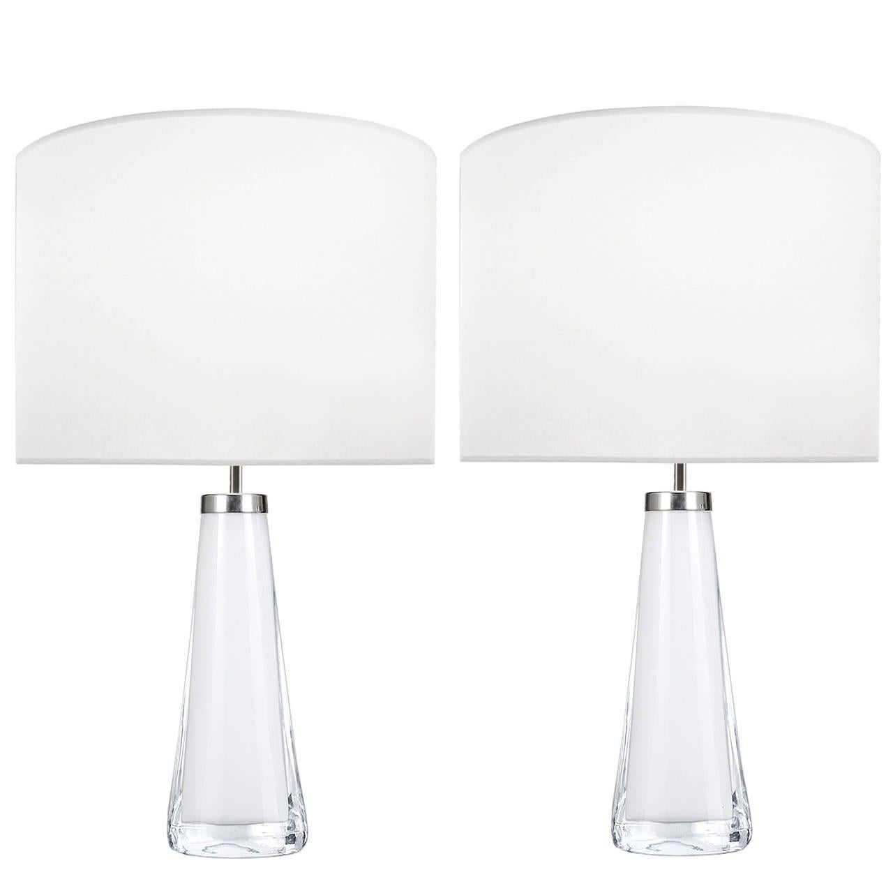 A pair of white glass lamps with thick clear glass casing with nickel hardware by Nils Landberg for Orrefors.

Swedish, Circa 1950's

Lamp Shades Are Not Included.

If you are interested in Lamp Shades, please email The Craig Van Den Brulle Design