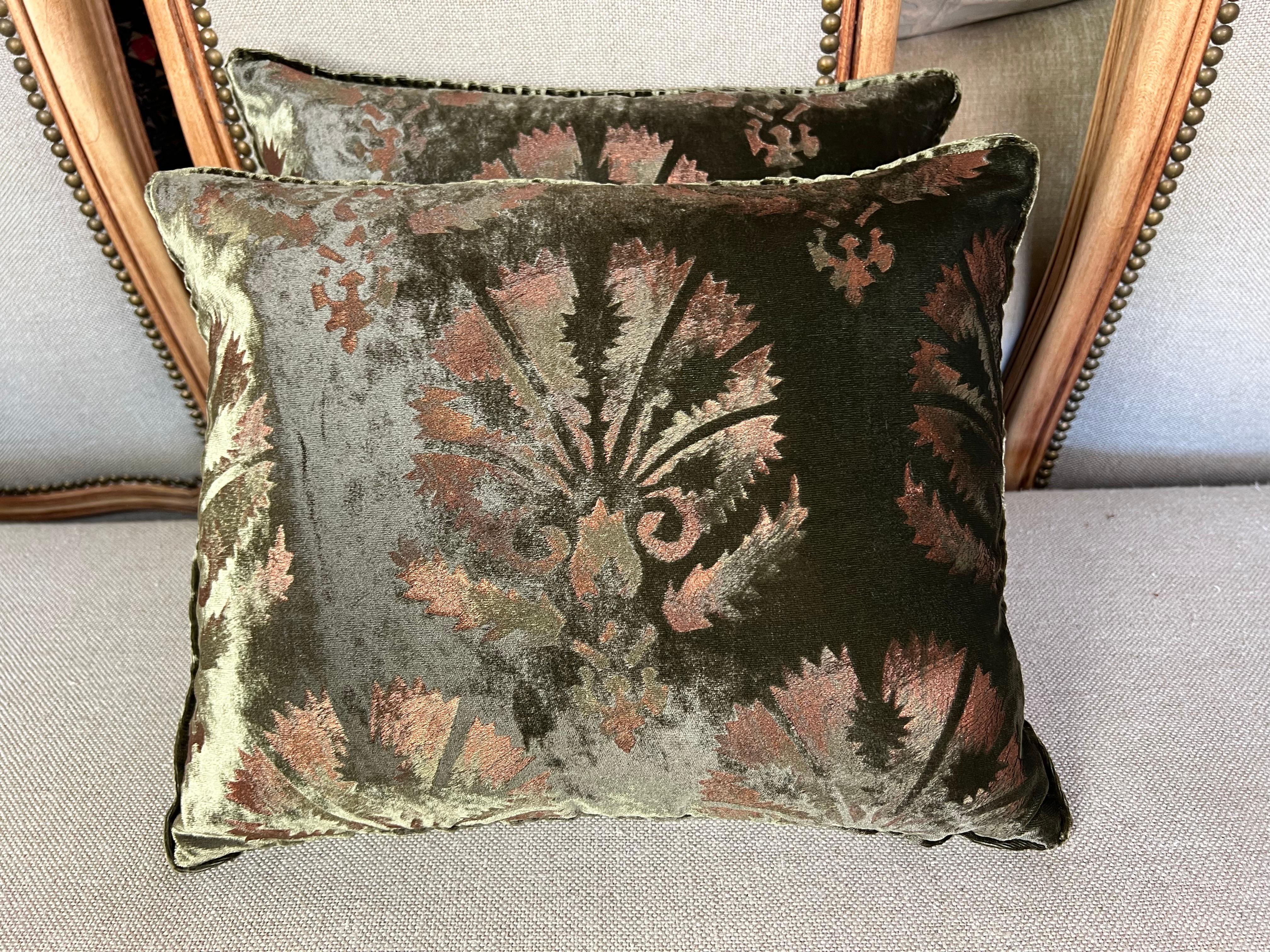 Pair of Custom Nomi Textiles olive green stenciled velvet pillows.  These pillows feature a damask design with delicate stenciling that has touches of pink and yellow on olive green velvet, backed with a coordinating olive green velvet.  The pillows