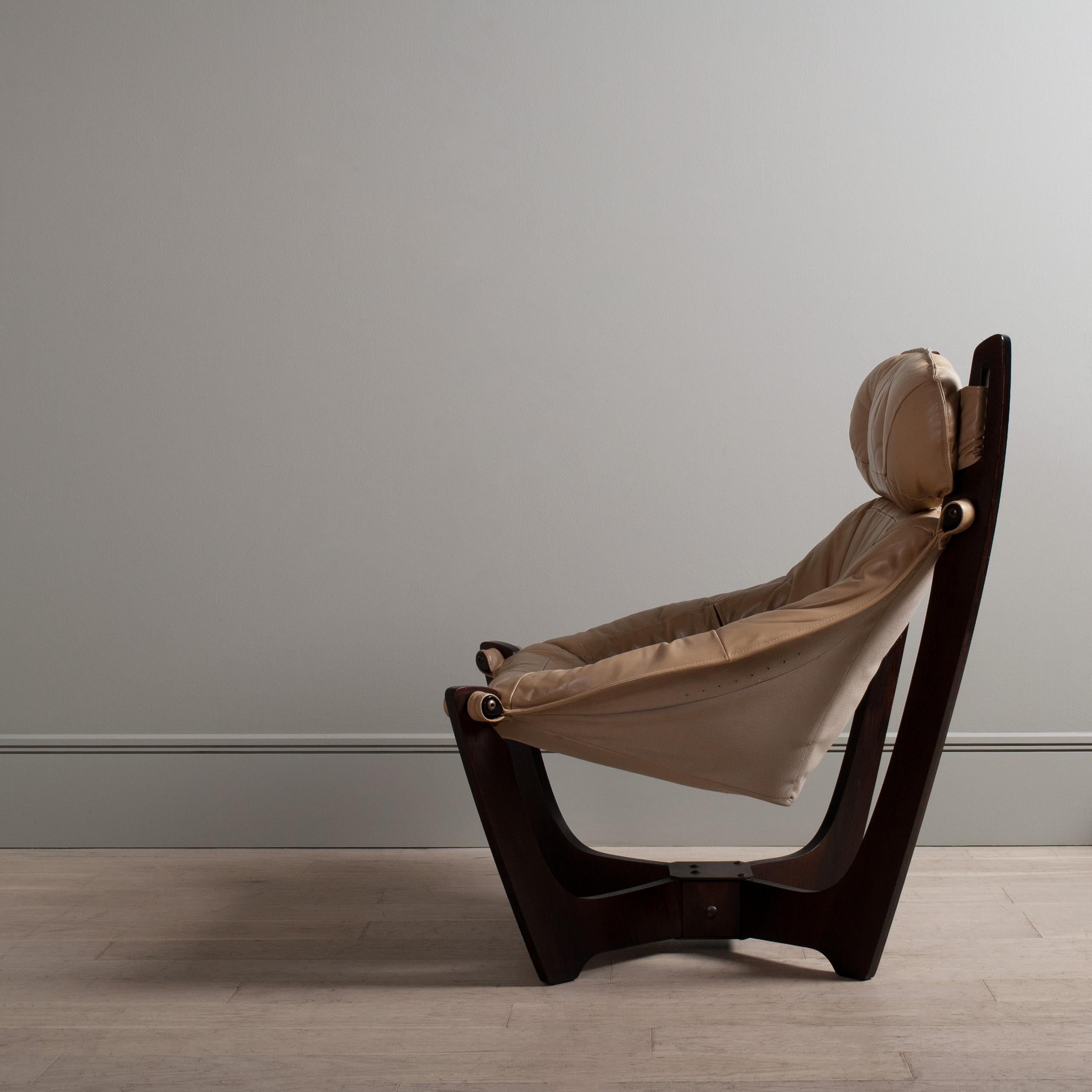 A pair of incredible lounge chairs by Norwegian designer Odd Knutsen. The Luna chair is a wonderful space age design that suspends the sitter within the wooden frame. A genius and complex design. The upholstery is leather and the frame dark rosewood