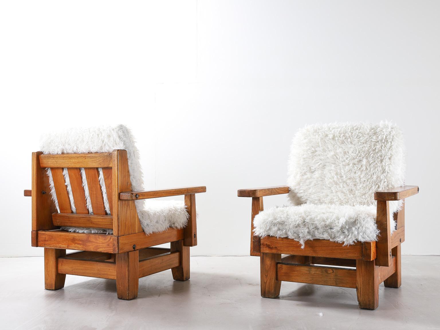 Pair of Northern Spanish armchairs with sheepskin upholstered cushions.

