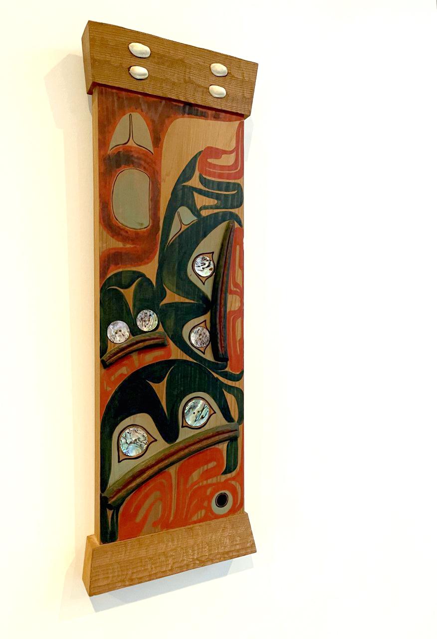 A lovely pair of wall hanging panels in the style of the native tribes of Northwest Pacific coast by artist Jean Ferrier in 1994. 
The panel was constructed from yellow cedar; Animalistic motifs were carved and painted on the surface in a classic