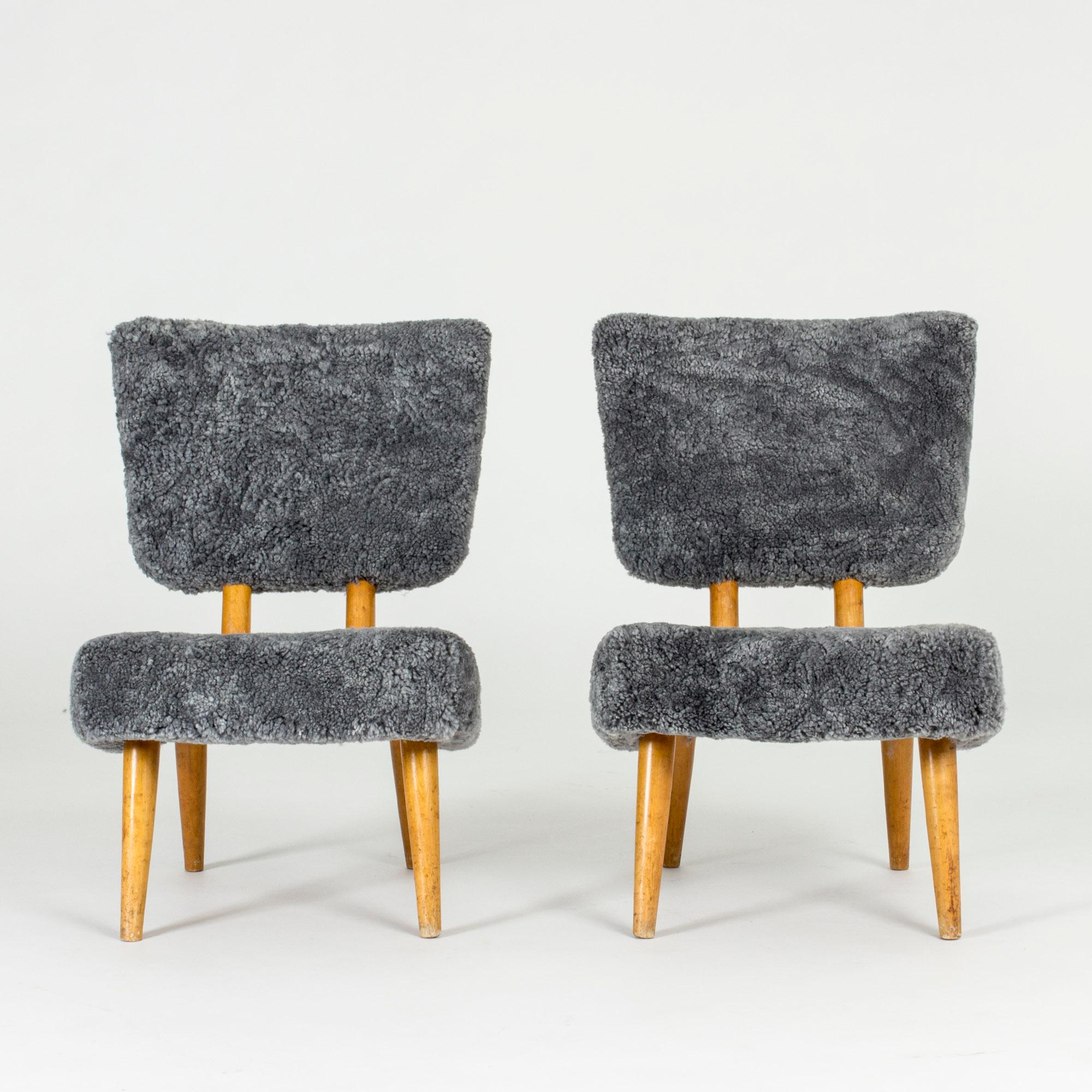 Pair of cheeky lounge chairs, made in Norway in the 1940s. Rare, neat model with high comfort and a light look. Reupholstered with sheepskin.
