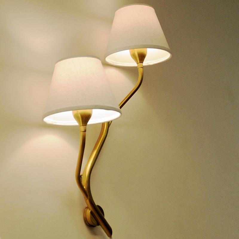 Typical midcentury Norwegian wall lamps made in brushed brass by Astra, circa 1956. Model 5691/4A. Shaped an d nicely sculpted as a tree branch and very decorative both as a pair or single.
Gives a calming light and fits in every room.
Measures