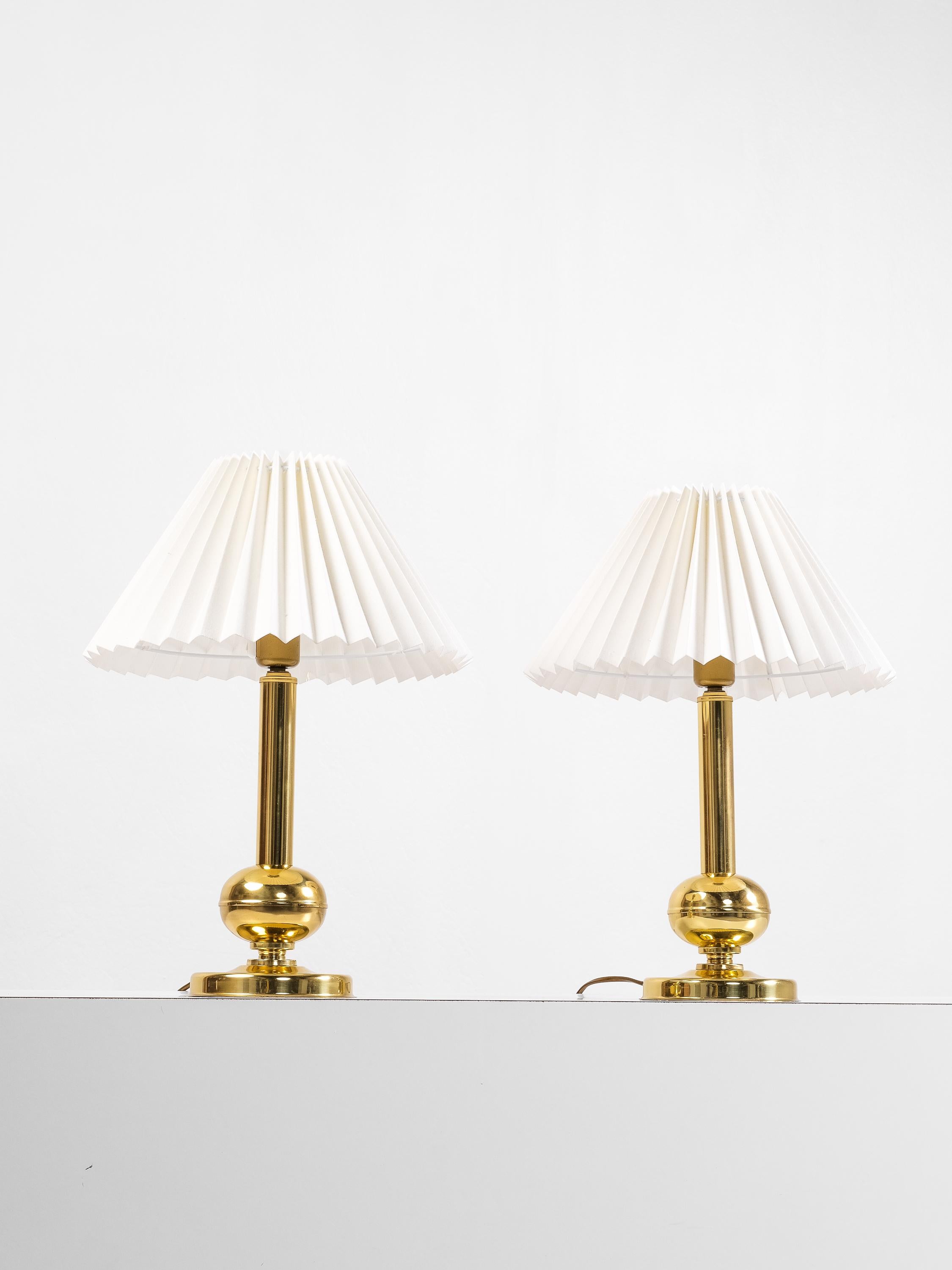 A sculptural and refined pair of mid-century brass table lamps designed by G. Johansen and produced in Norway during the 1960s. These lamps feature a bold yet elegant form, with a polished brass column rising from a spherical accent and resting on a