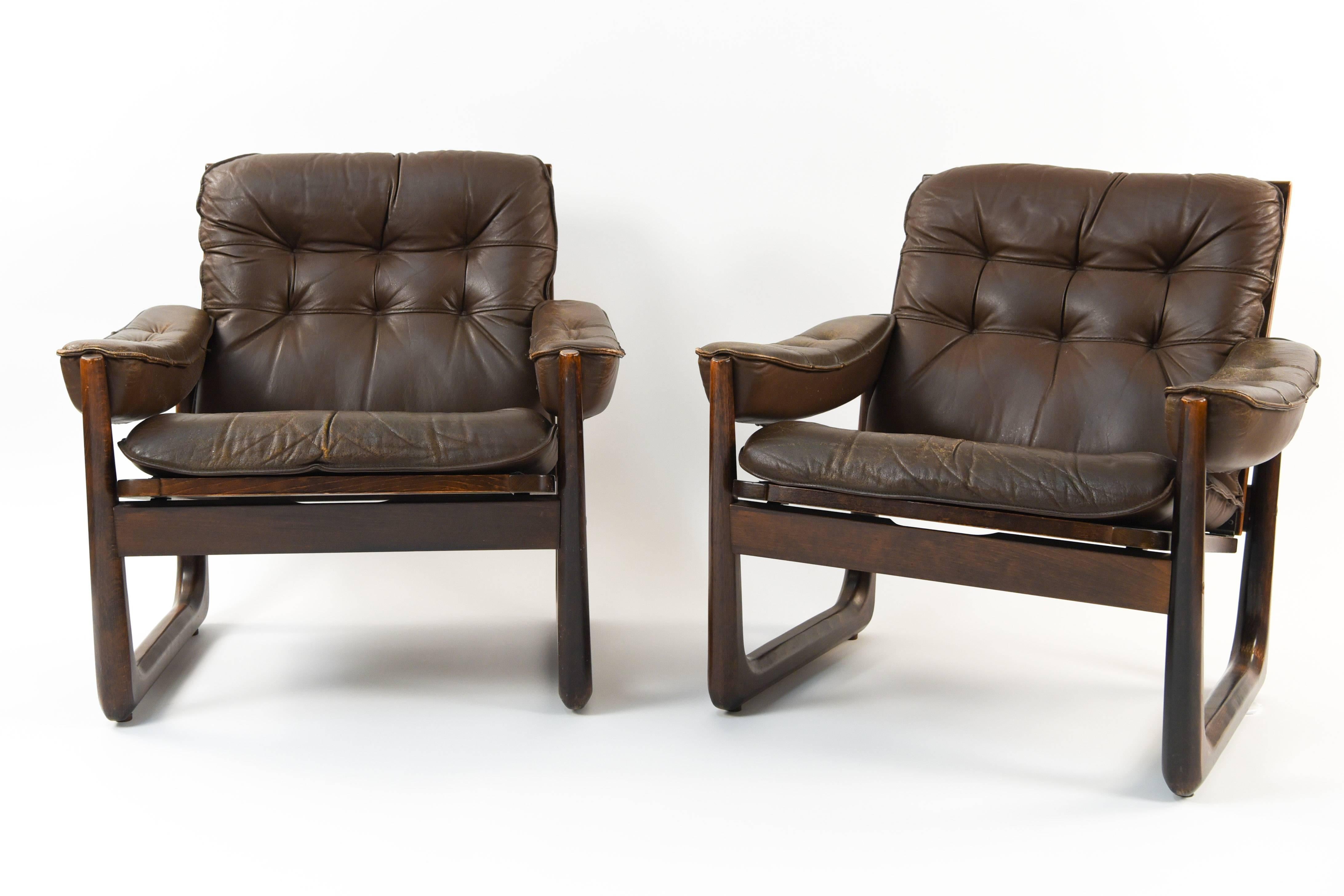 Designed by Oddvar Vad and produced by Vad Trævarefabrik, Norway. These lounge / armchairs feature tufted brown leather upholstery and stained beech frames. A great example of Scandinavian modern design, circa 1970s.