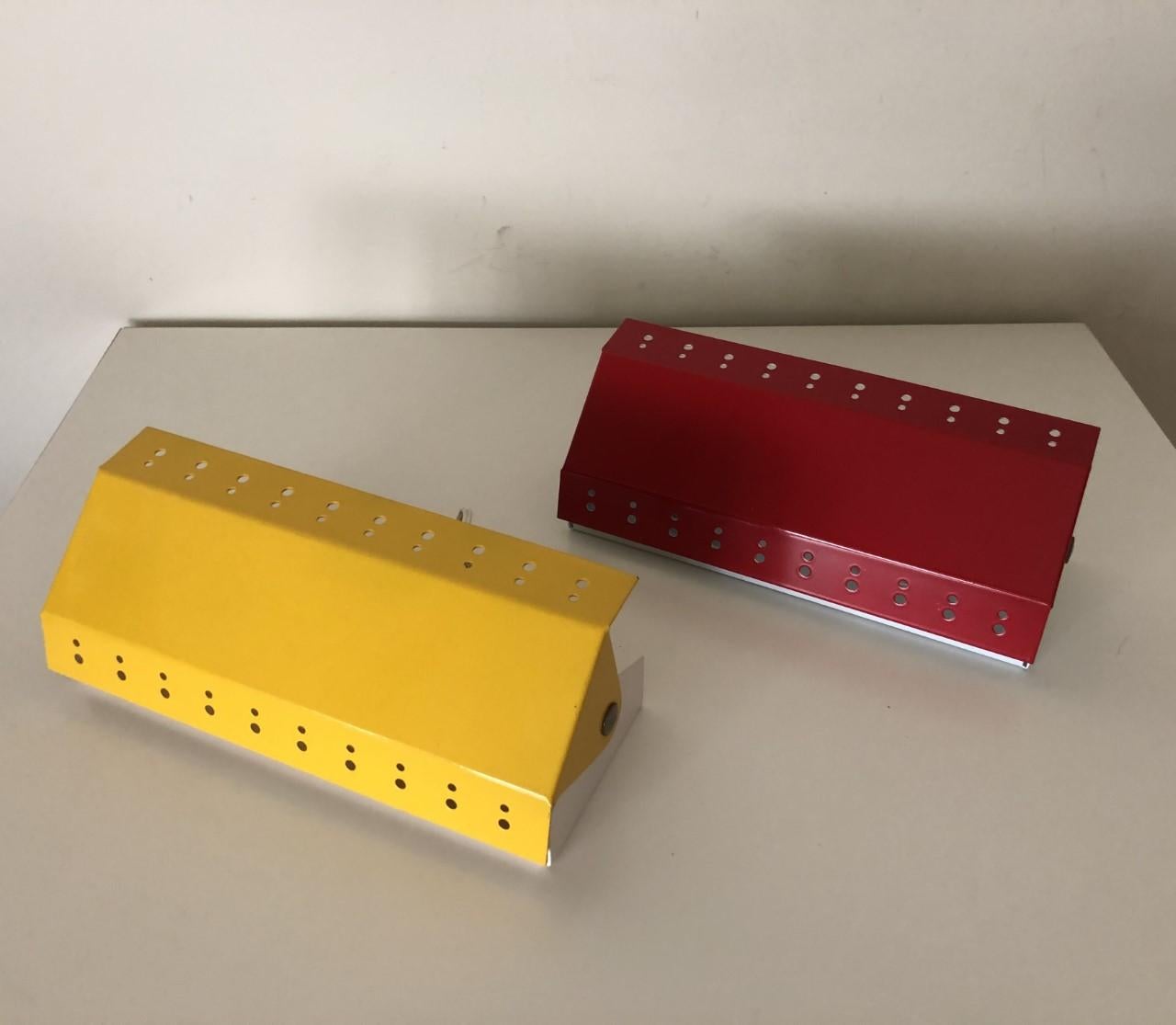 Lovely and beautiful pair of Norwegian perforated metal red yellow wall sconces from 1970s.
They are stock of a Lighting store from the 1970s in Barcelona. Therefore theses pieces are without use, perfect condition.
Each wall sconce is equipped